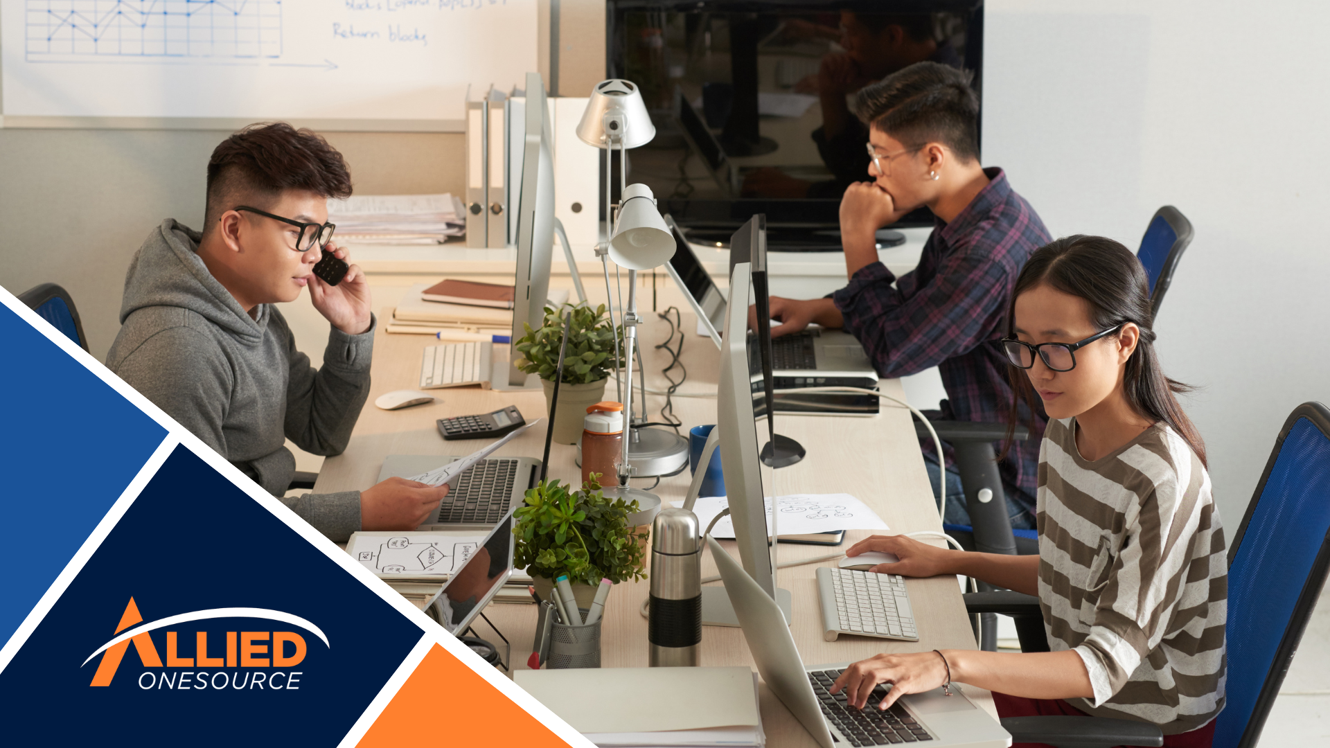 Office employees working at modern desks with computers.