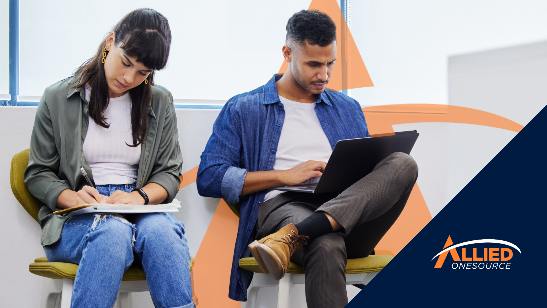 Two job seekers reviewing notes and browsing on a laptop, putting their job search strategy to work