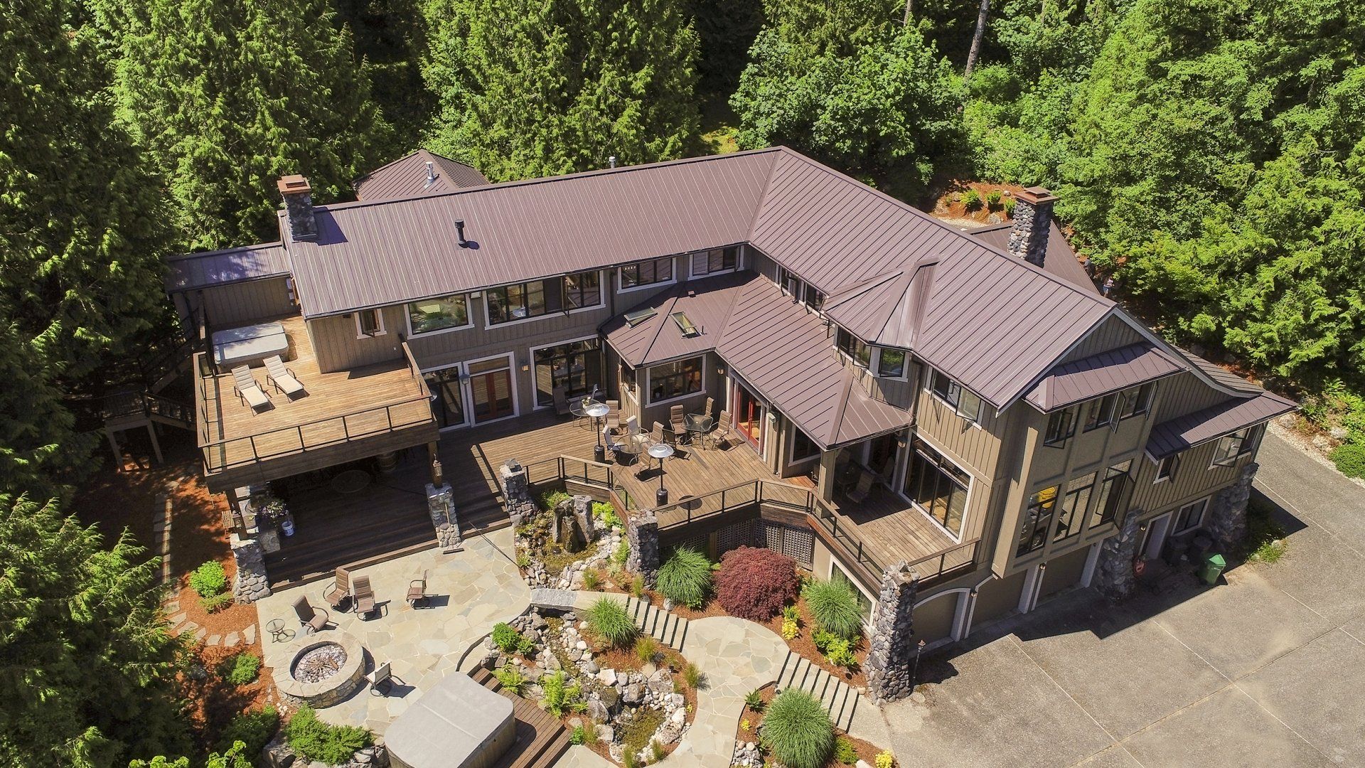 An aerial view of a large house surrounded by trees.