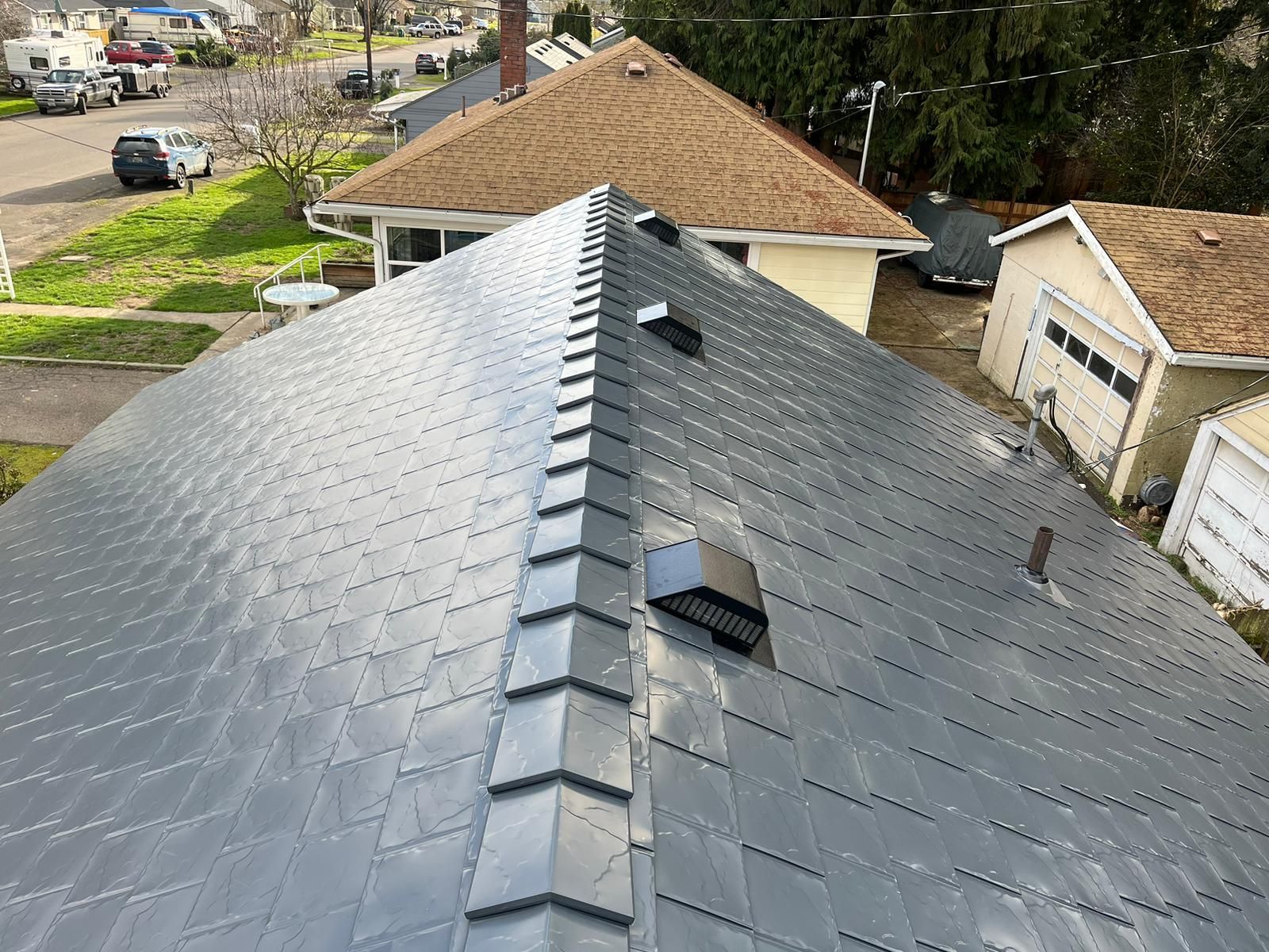 An aerial view of a house with a metal roof.