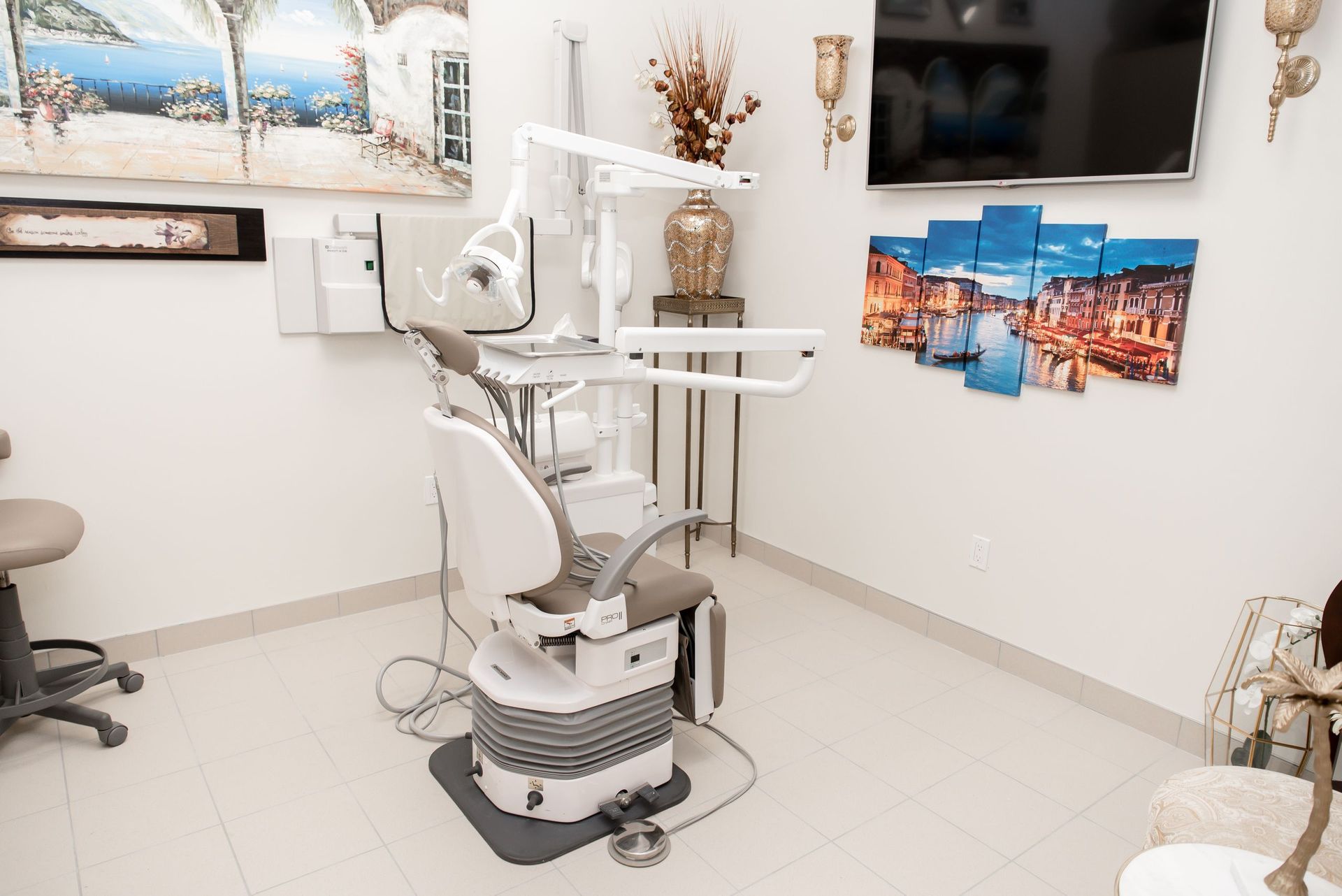 A dental office with a dental chair and a television.
