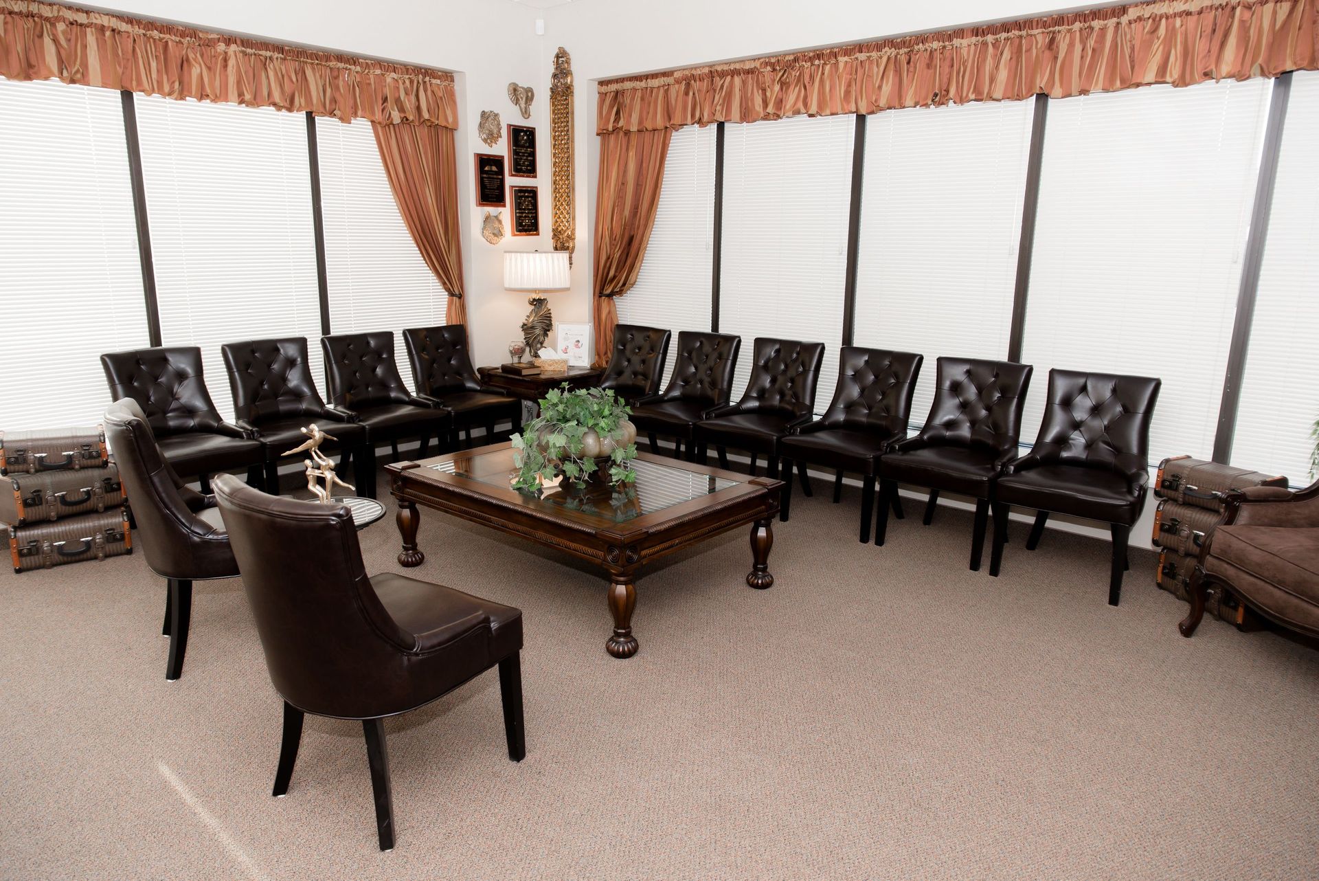 There are many chairs and a coffee table in the room.