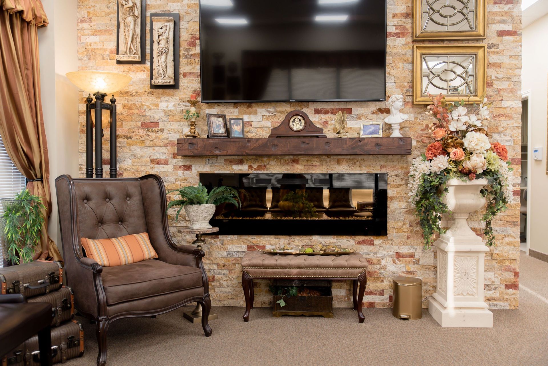 A living room with a fireplace , chair , television and clock.