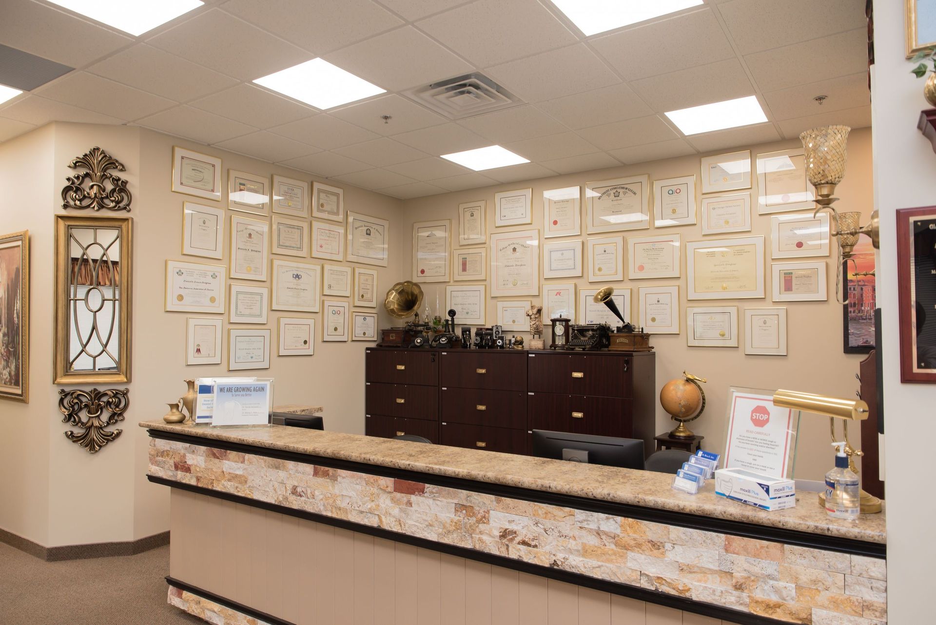 A reception desk in a room with a lot of pictures on the wall.