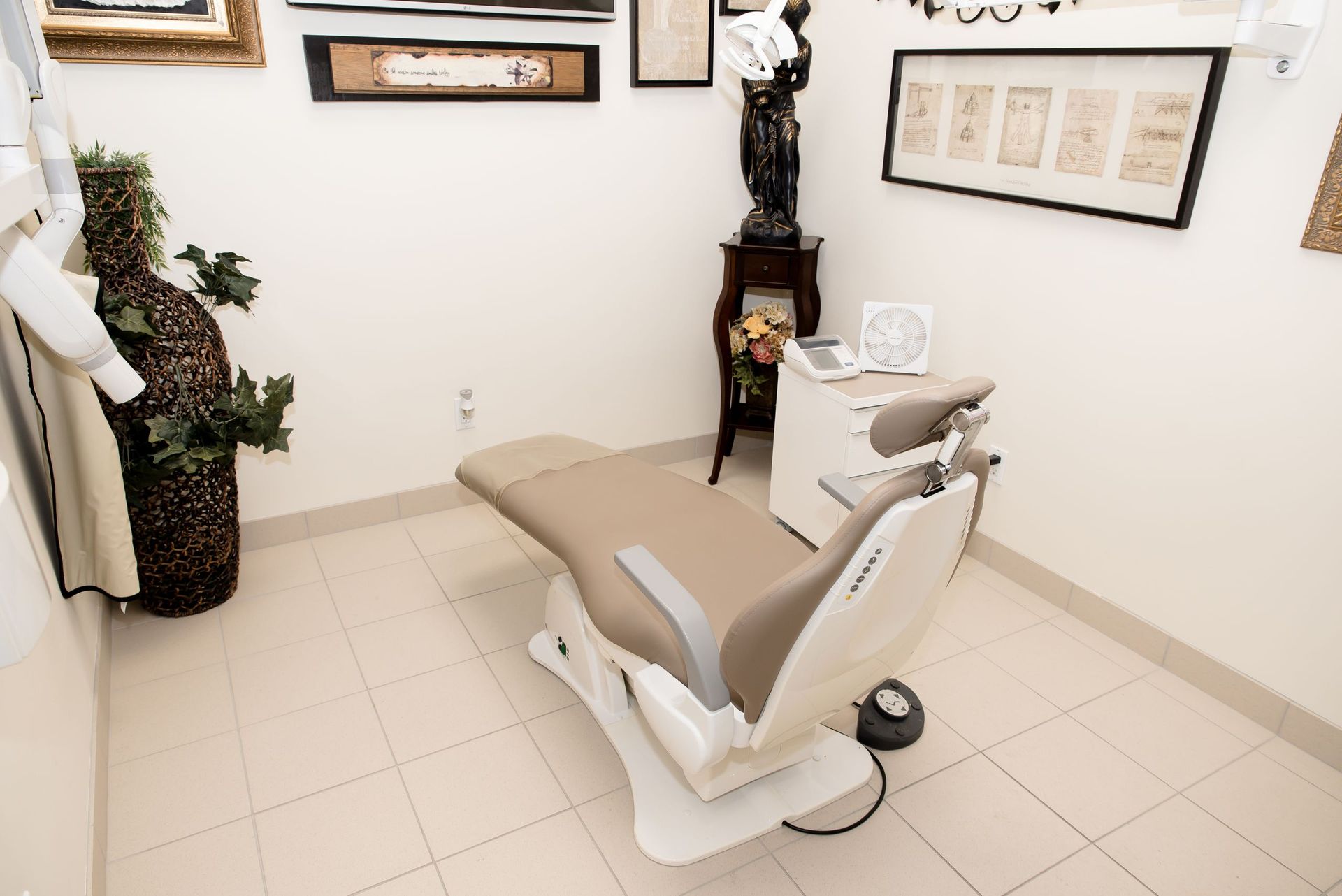 There is a dental chair in the middle of the room.