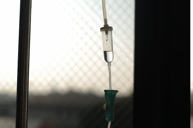 a close up of an intravenous drip hanging from a window .
