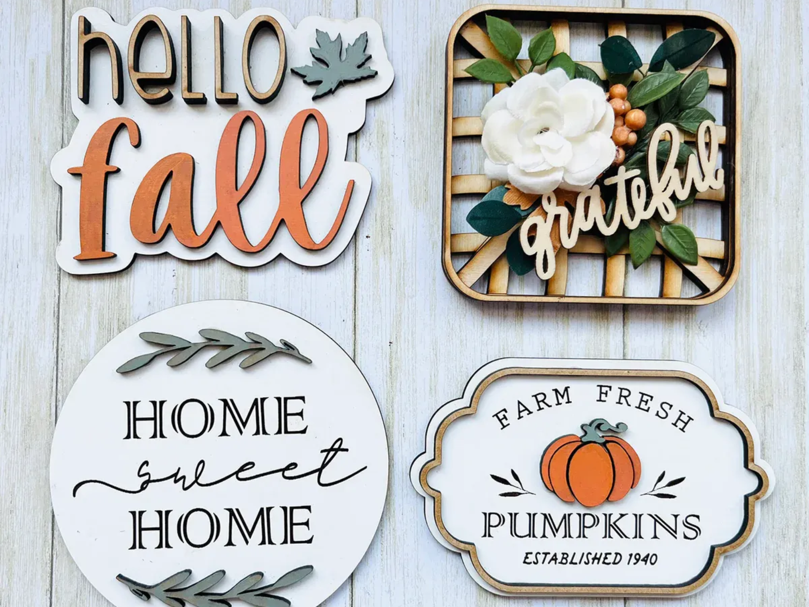 Four fall-themed wooden signs: