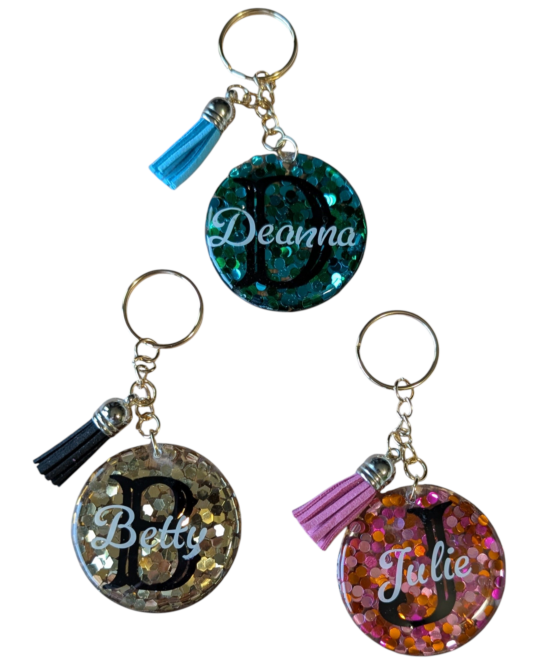Assorted glitter keychains personalized with names and initials