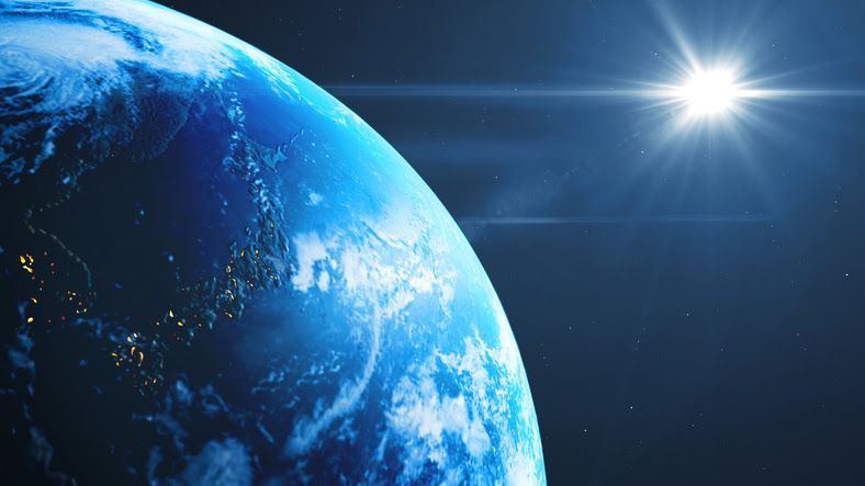 Earth from space with a bright star and lights from cities in the United States of America.