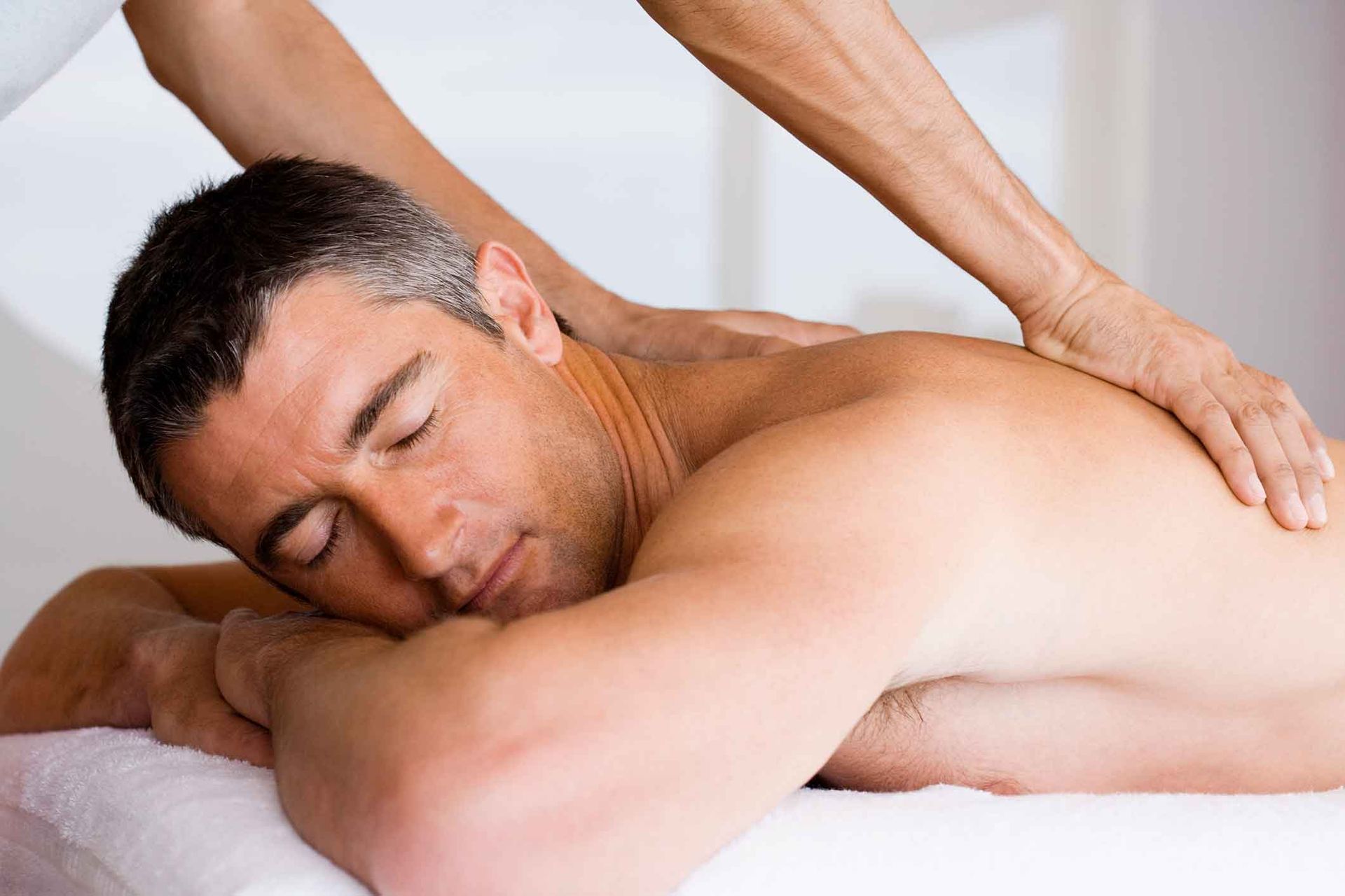 A Man Is Laying On A Table Getting A Massage – Coral Springs, FL - Life In Motion Bodyworks and Aesthetics