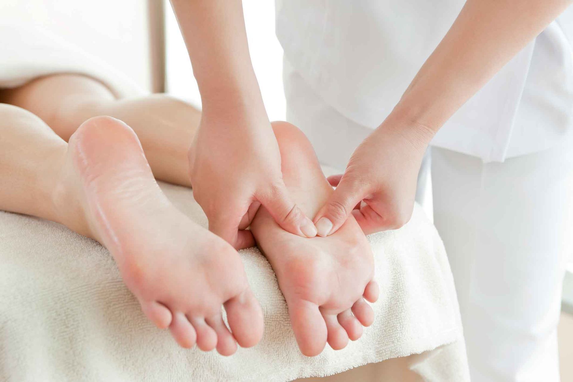 A Woman Is Getting A Foot Massage From A Nurse – Coral Springs, FL - Life In Motion Bodyworks and Aesthetics