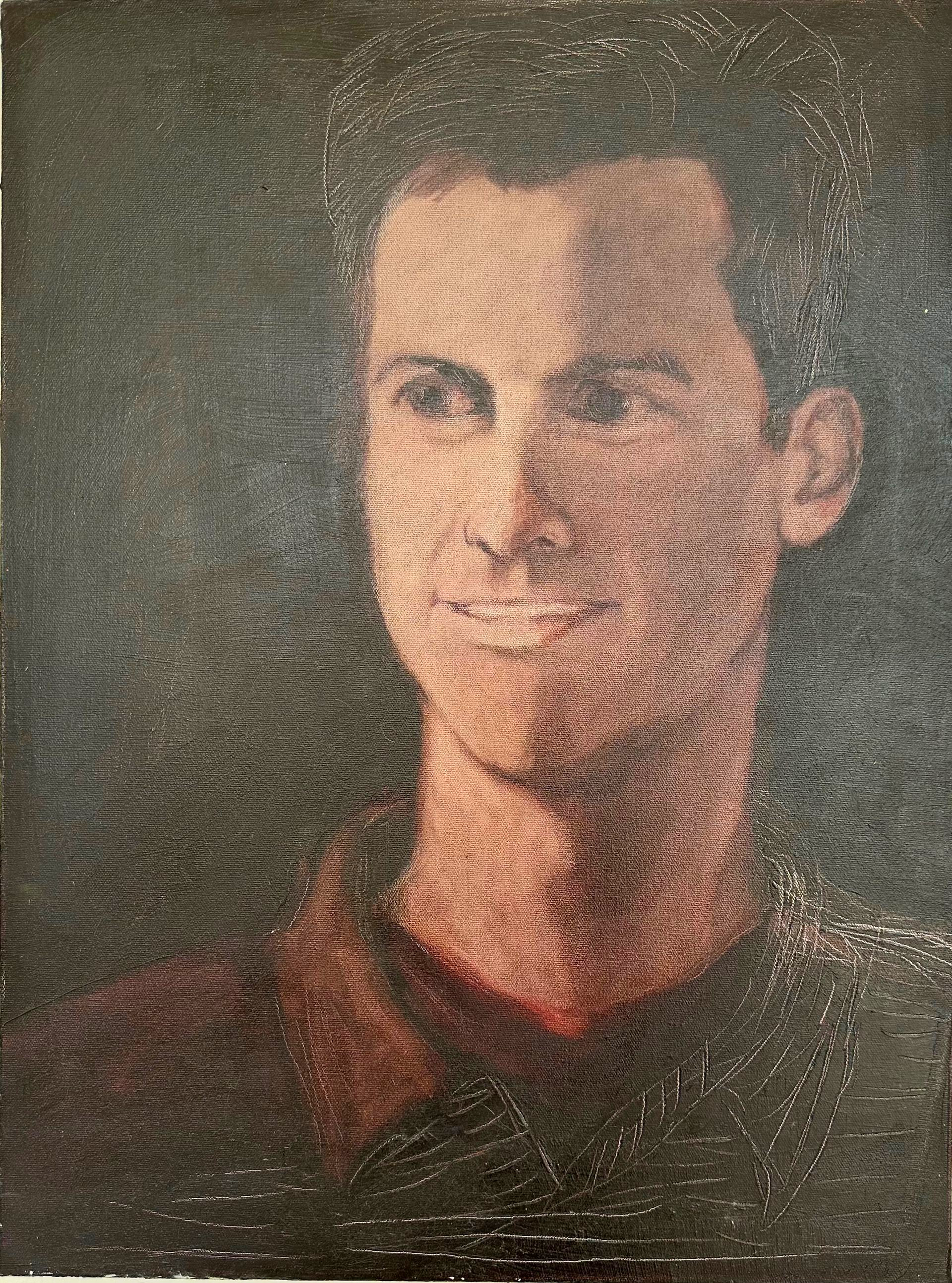 Portrait of a person in a dark shirt, facing forward against a dark background.