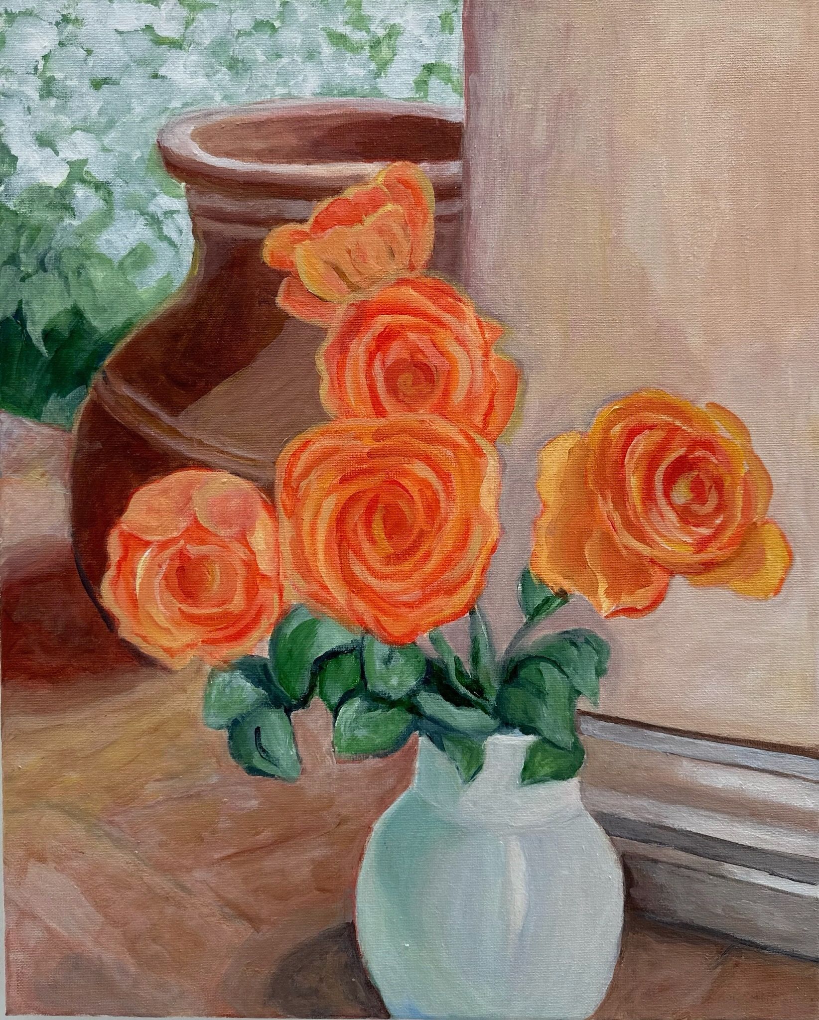 Orange roses in a white vase beside a terracotta pot on a windowsill