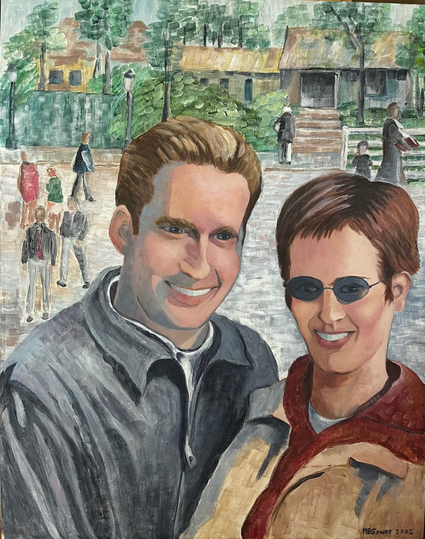 Smiling couple in sunglasses in a park, with people walking and trees in the background.