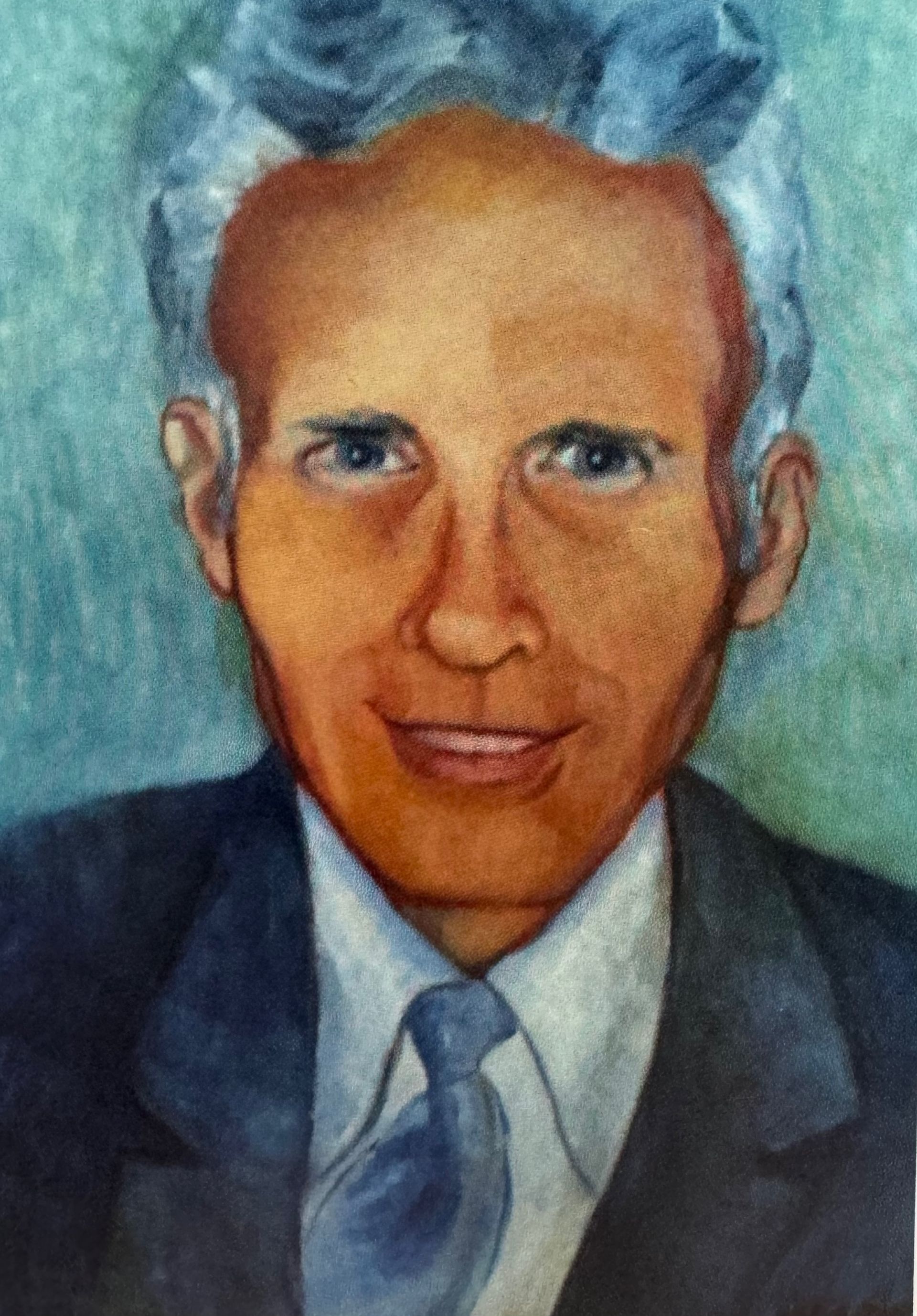 Portrait of a man in a suit and tie with short gray hair on a blue background