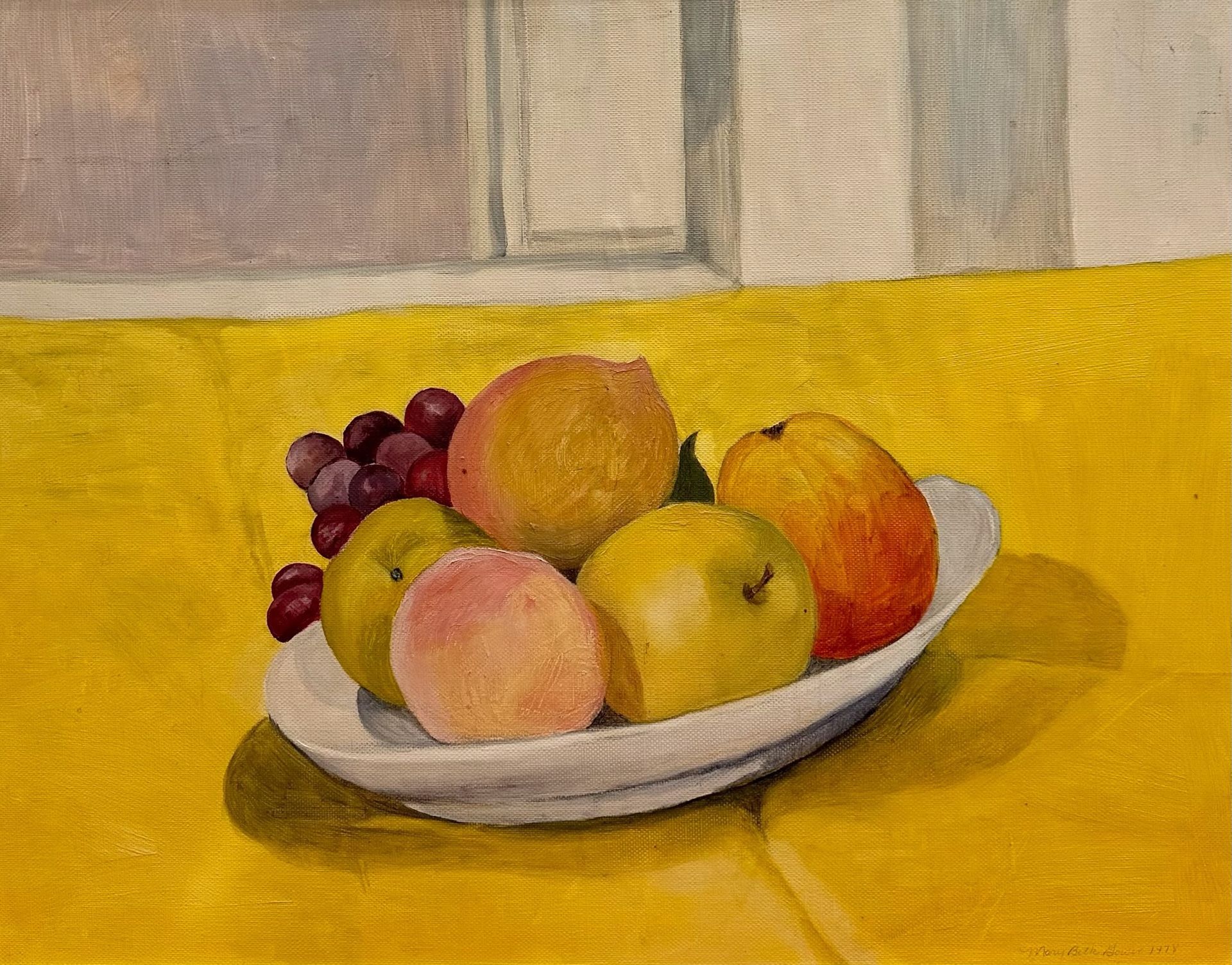 Bowl of colorful fruit on a yellow tablecloth against a neutral background