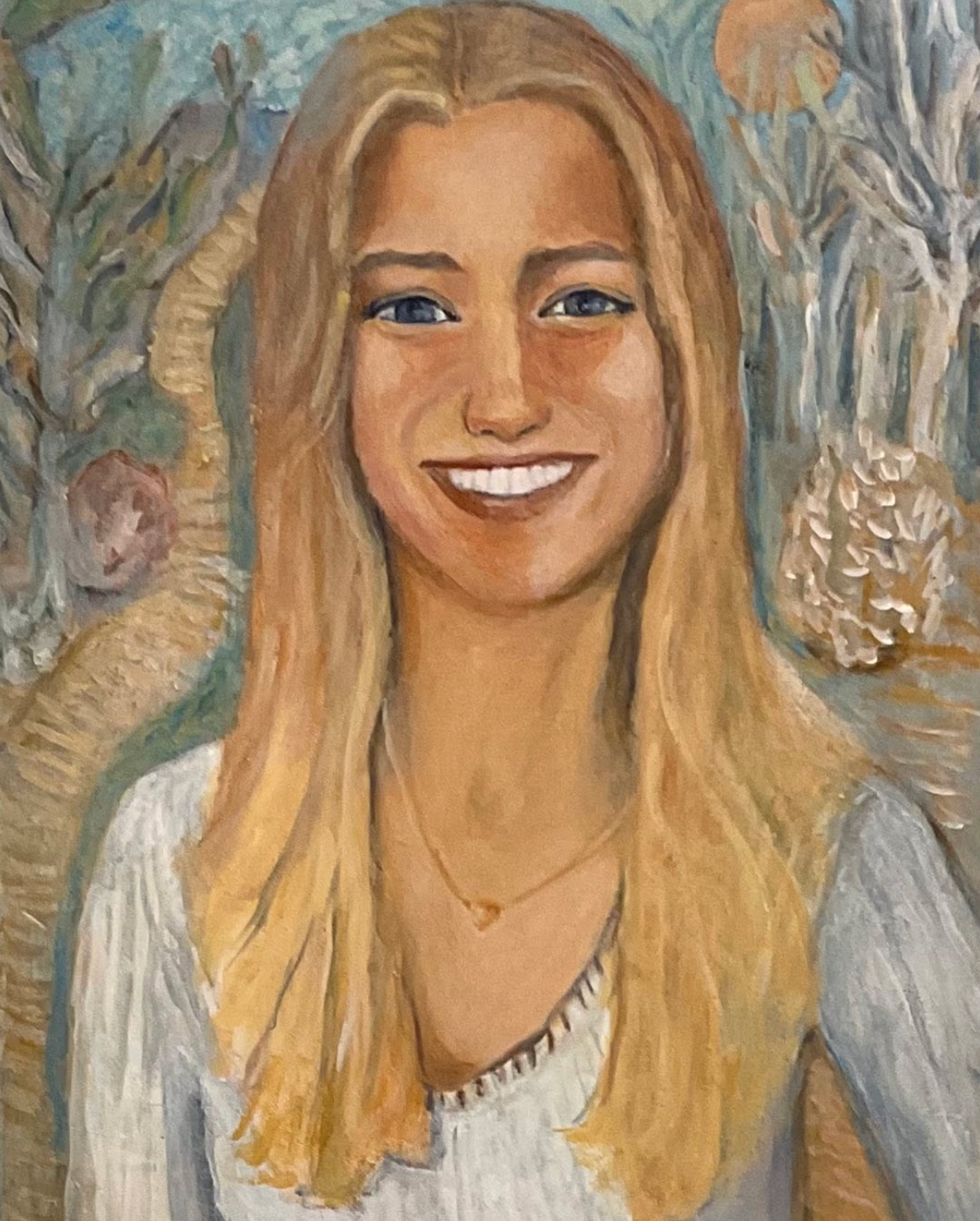 Portrait of a smiling blonde woman in a white top against a floral background