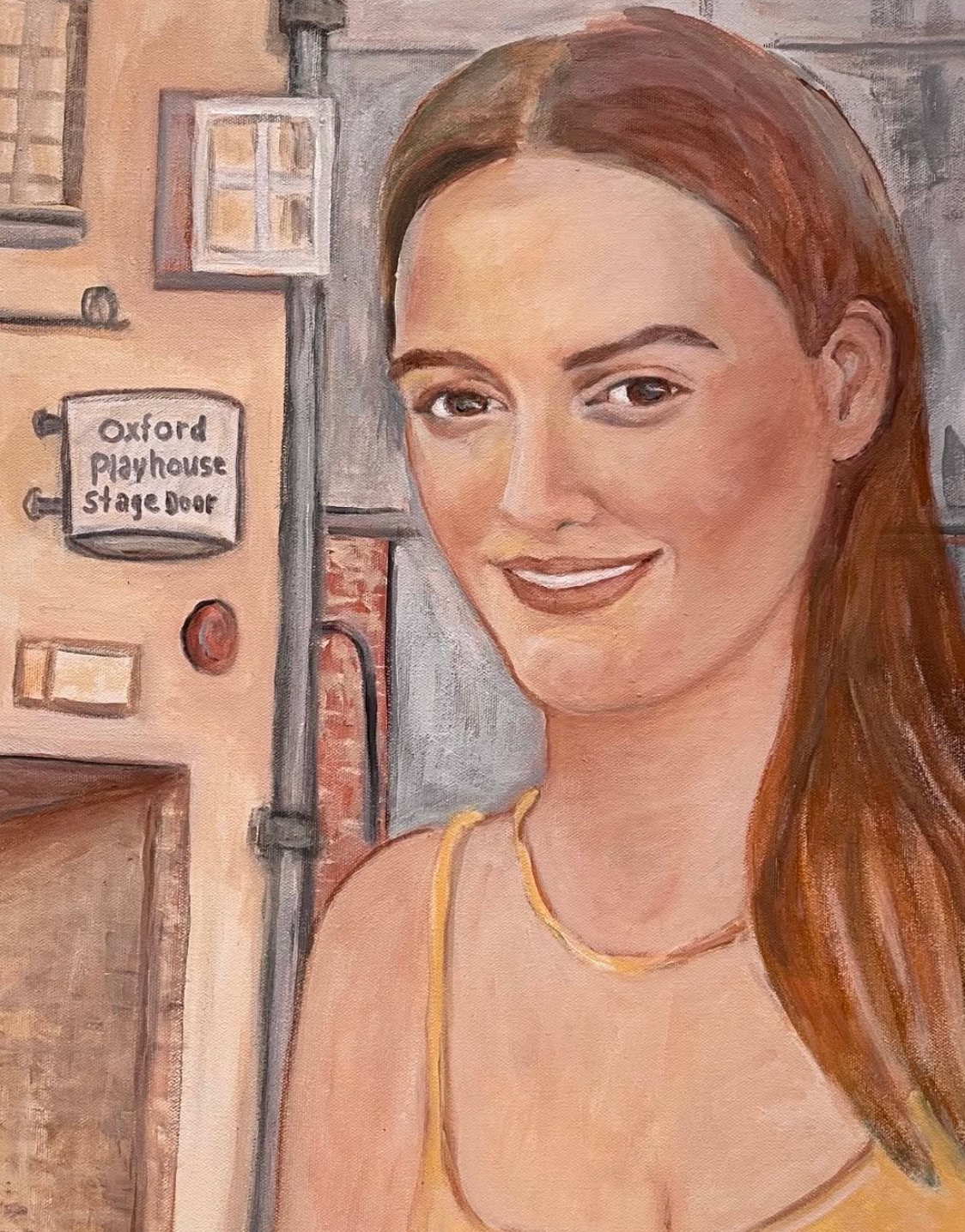 Smiling woman in a peach top stands by a door labeled “Oxford Playhouse Stage Door.”