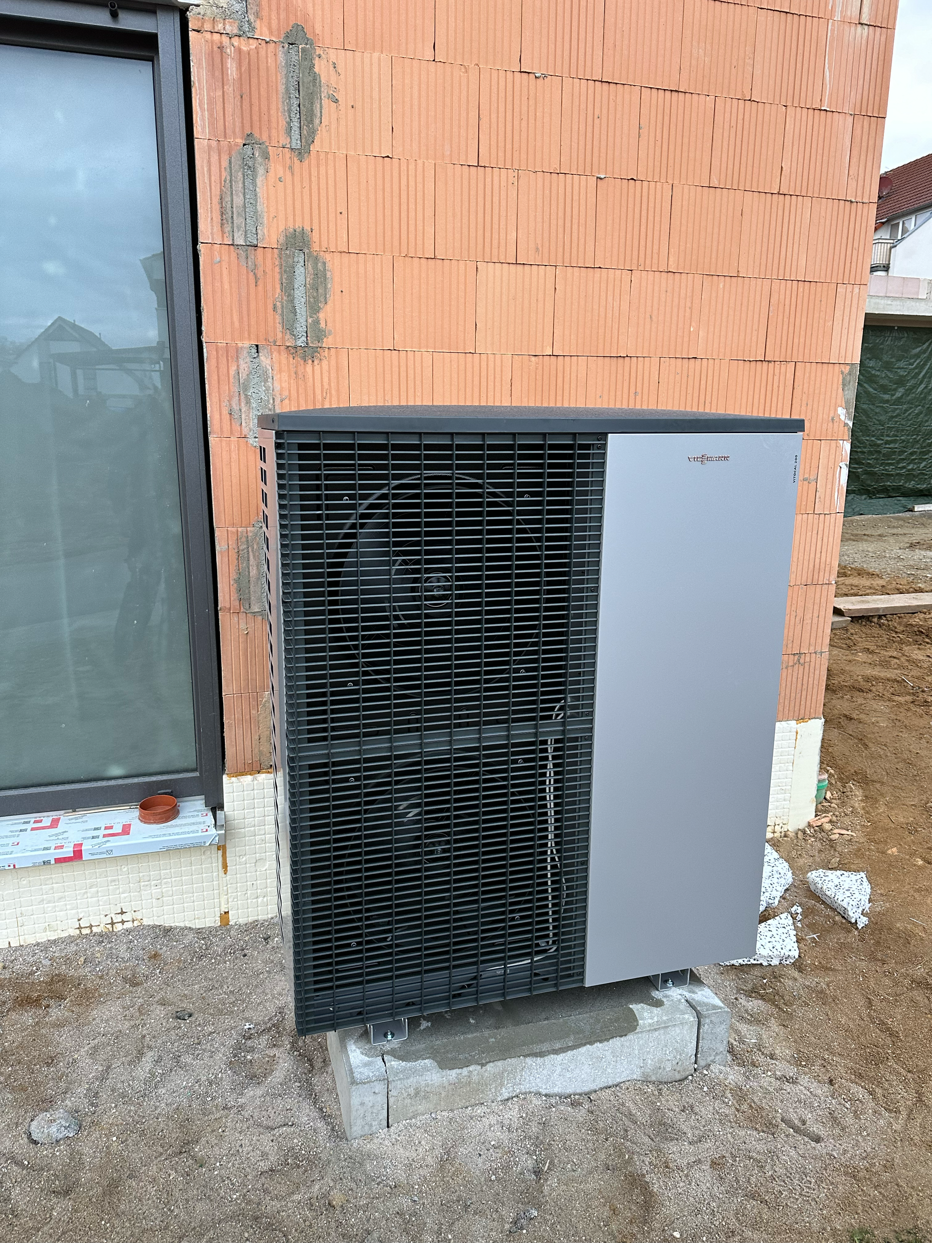 An der Seite eines Backsteingebäudes steht eine große Klimaanlage.