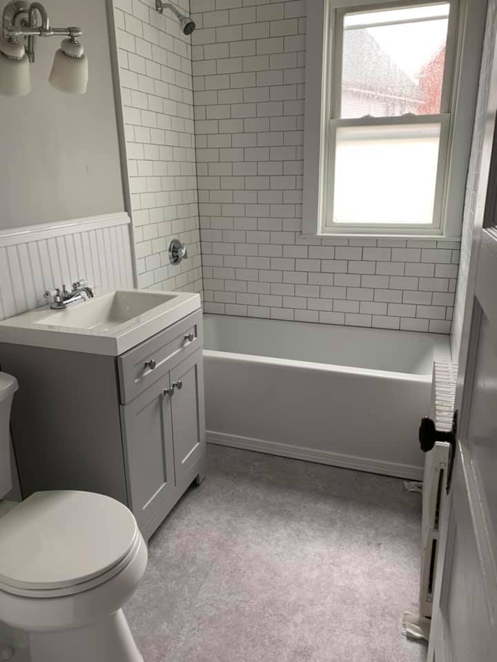bathroom remodel with vanity and tub.