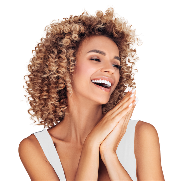 A woman with curly hair is smiling and covering her face with her hands