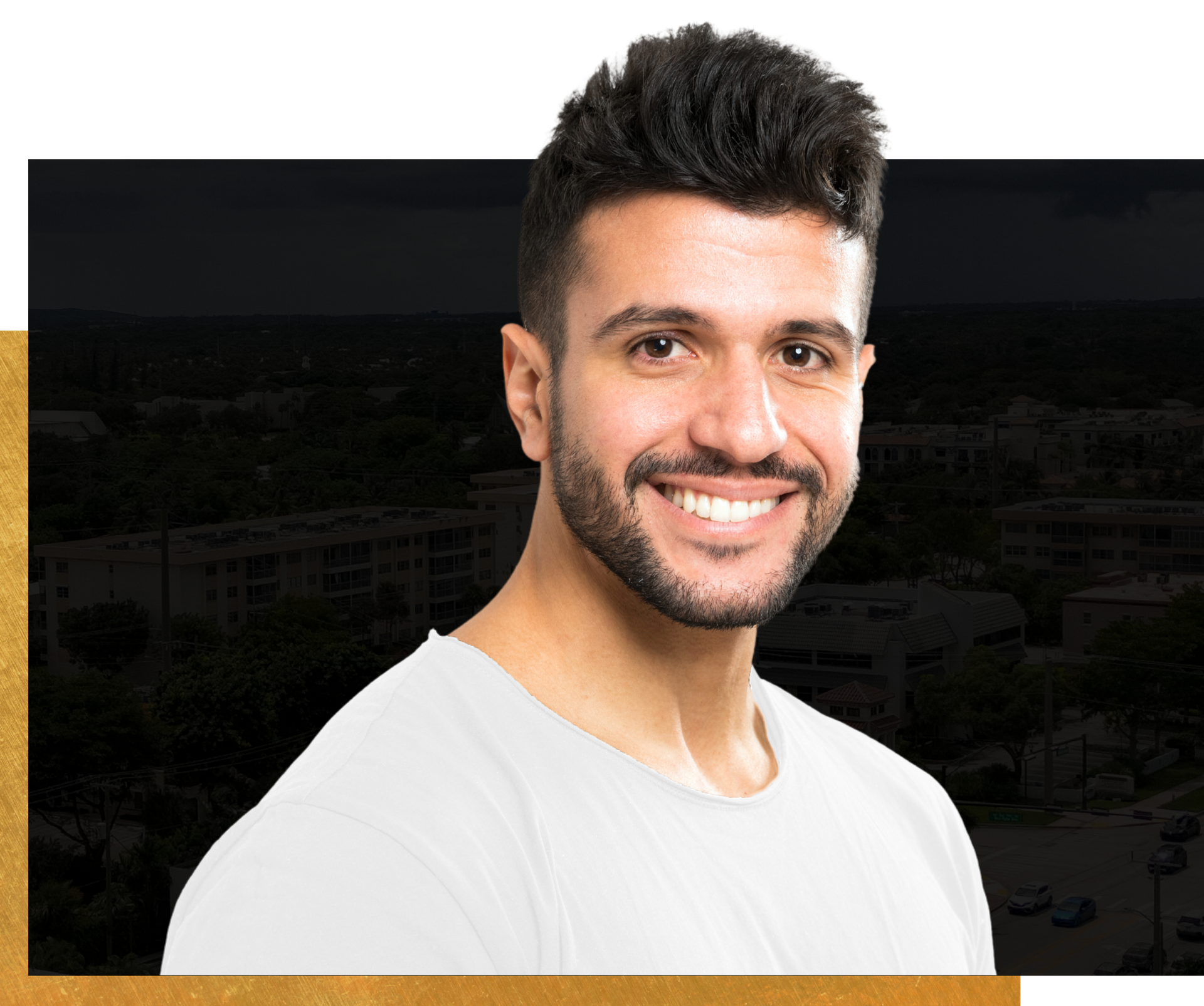 A man with a beard is smiling for the camera while wearing a white shirt.