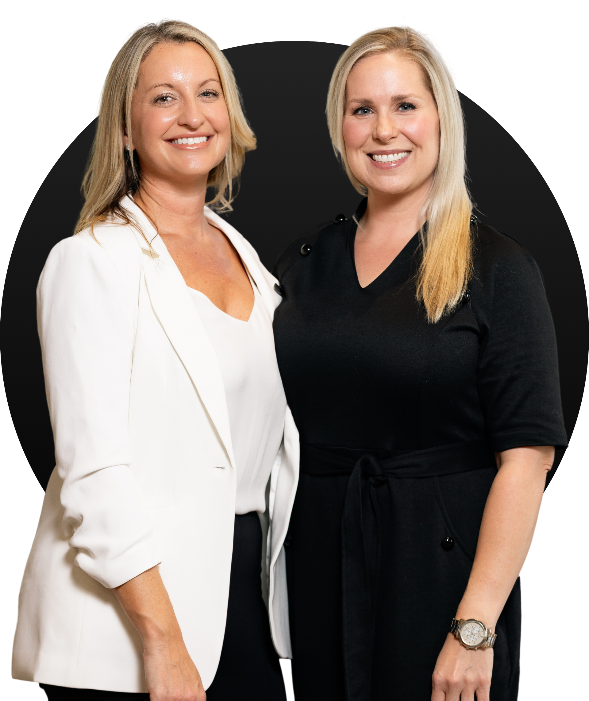 Two women are standing next to each other and smiling for the camera