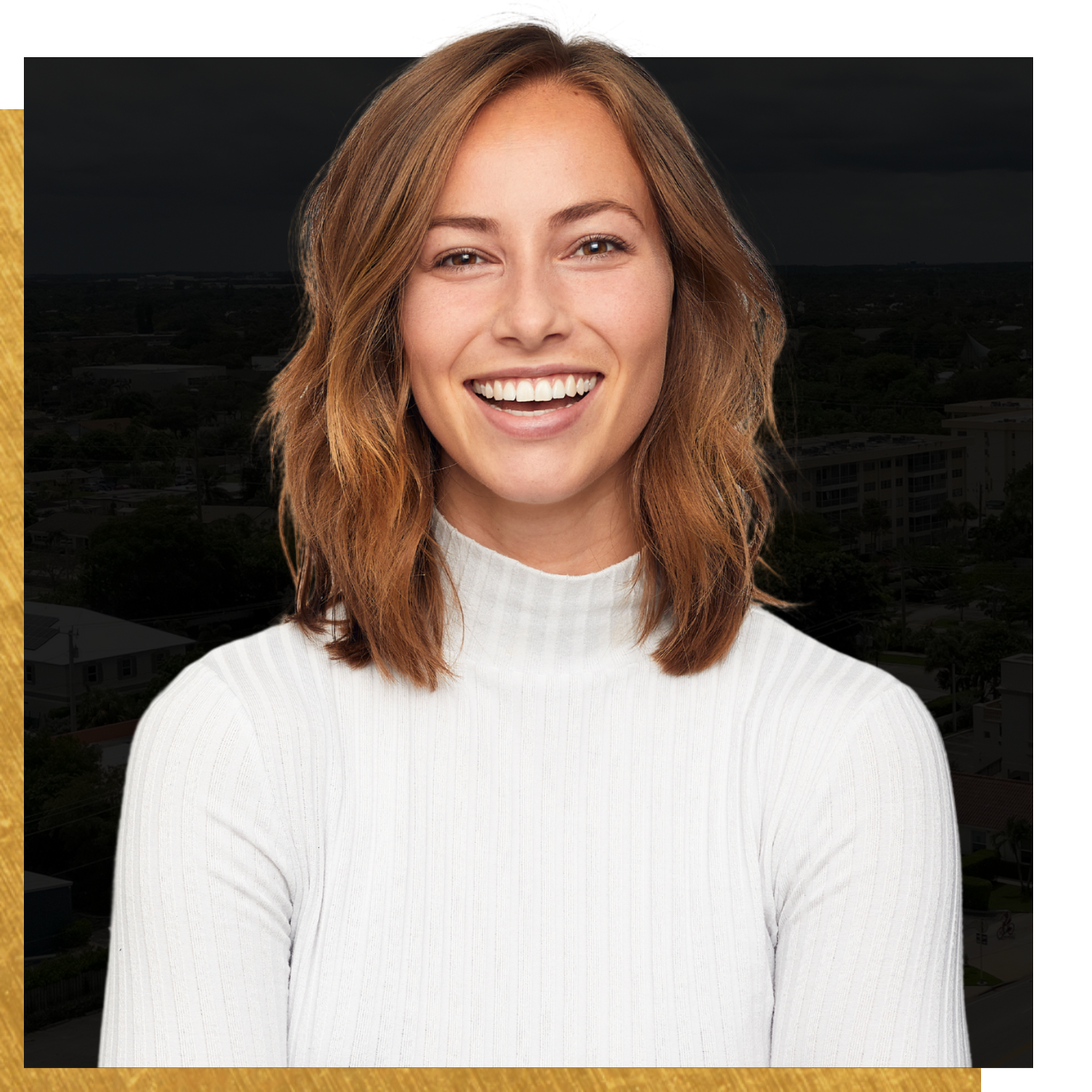 A woman in a white sweater is smiling for the camera