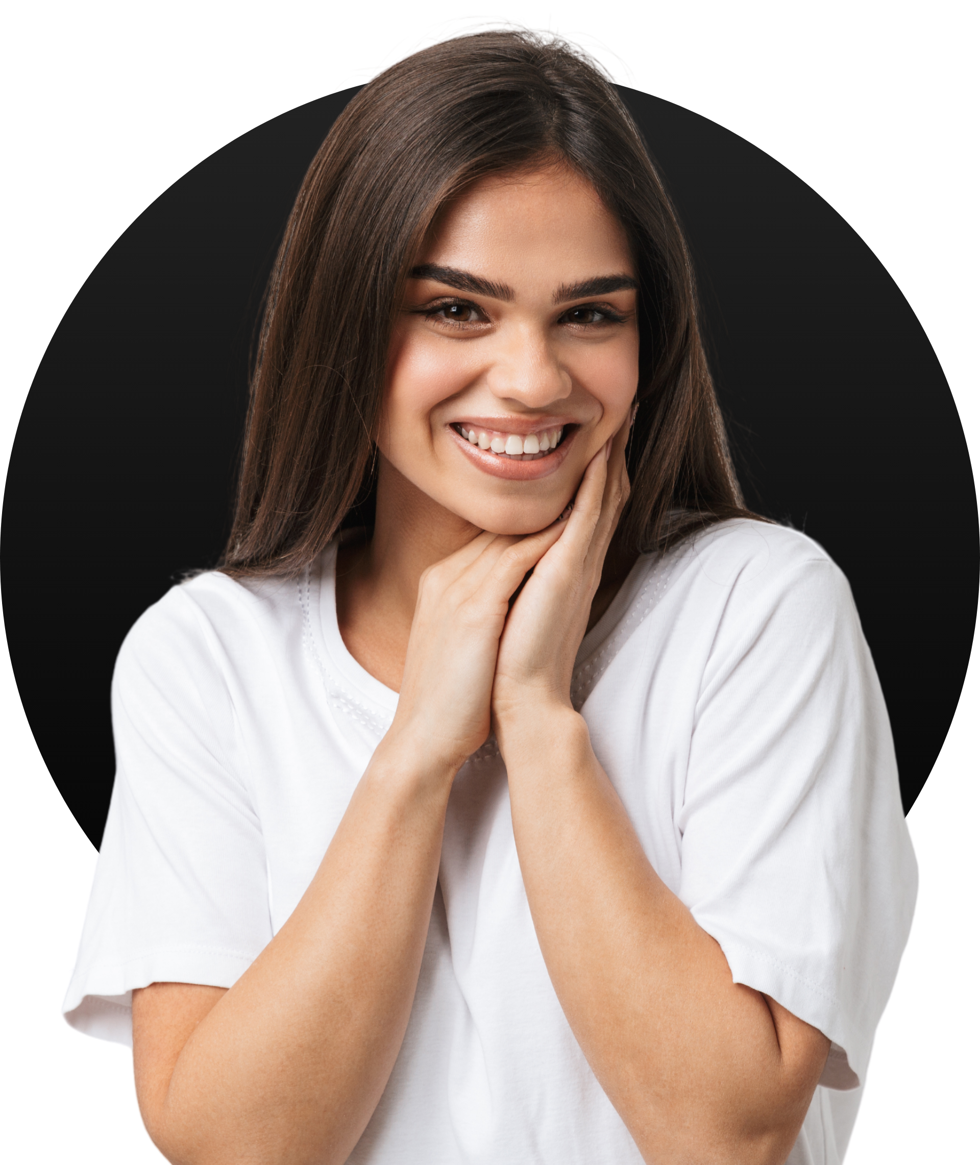 A woman in a white shirt is smiling with her hands on her face