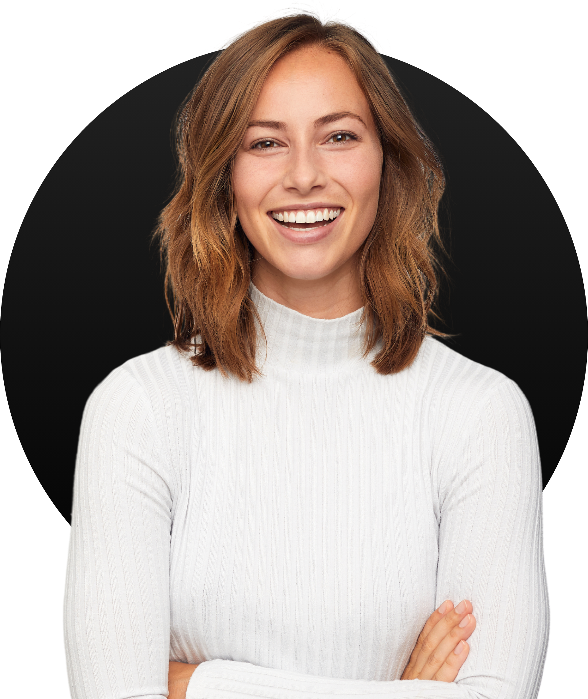 A woman in a white sweater is smiling with her arms crossed