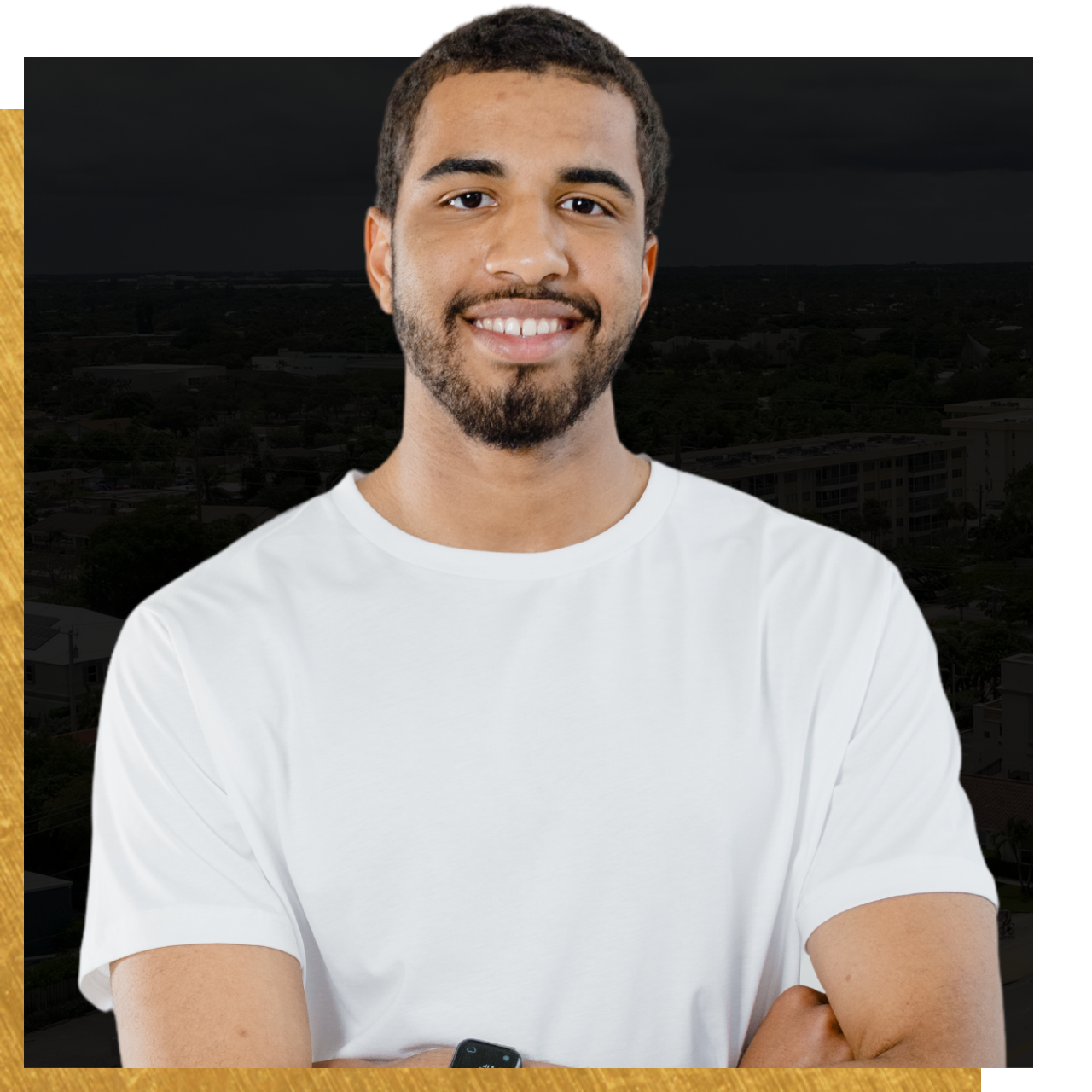 A man with a beard is wearing a white shirt and smiling