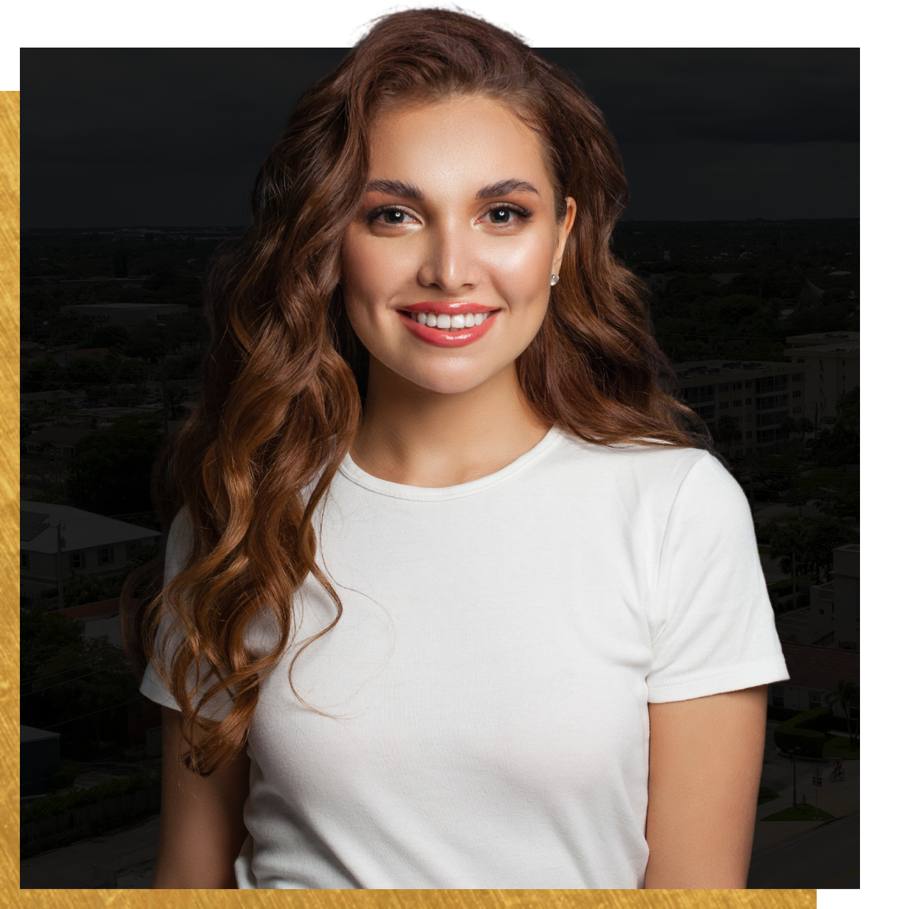 A woman with long hair is wearing a white t-shirt and smiling