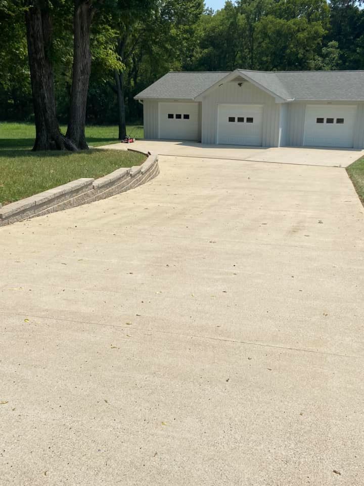 Brightened driveway in Lebanon, TN, after professional pressure washing and sealing services.