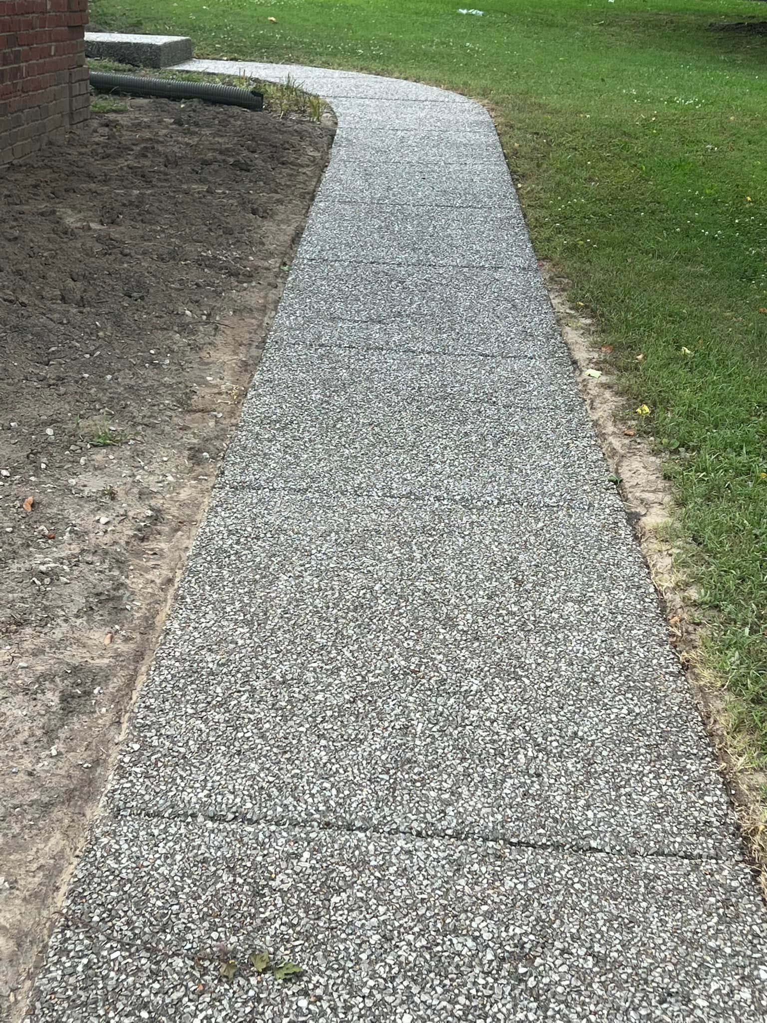 Cleaned driveway in Lebanon, TN, after professional driveway sealing and pressure washing services.