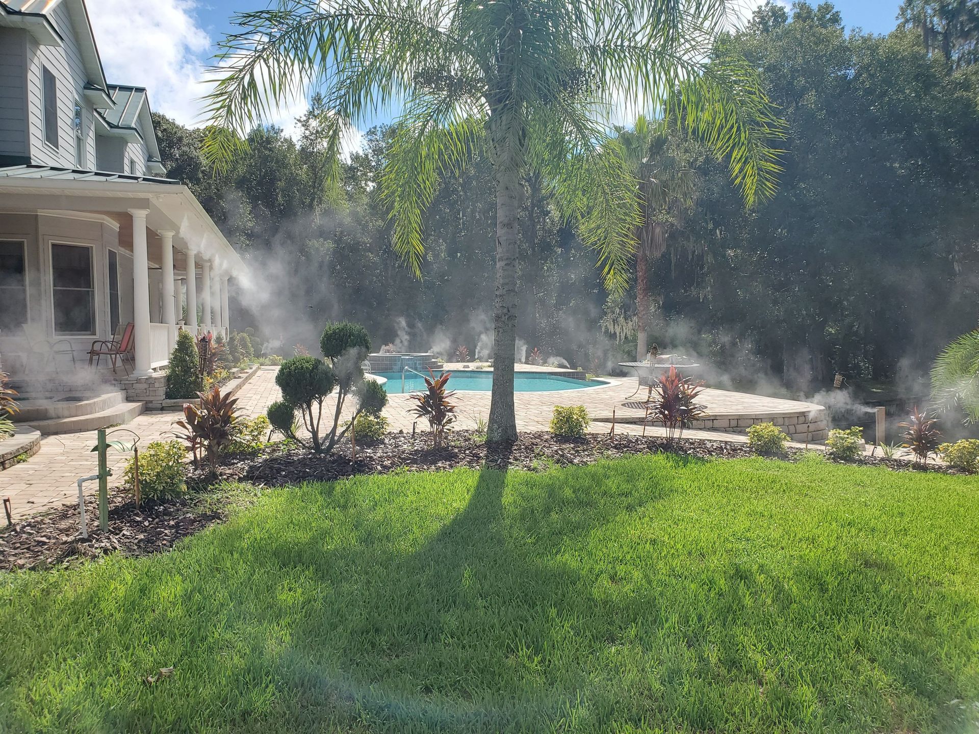 Lawn with misting system near a house
