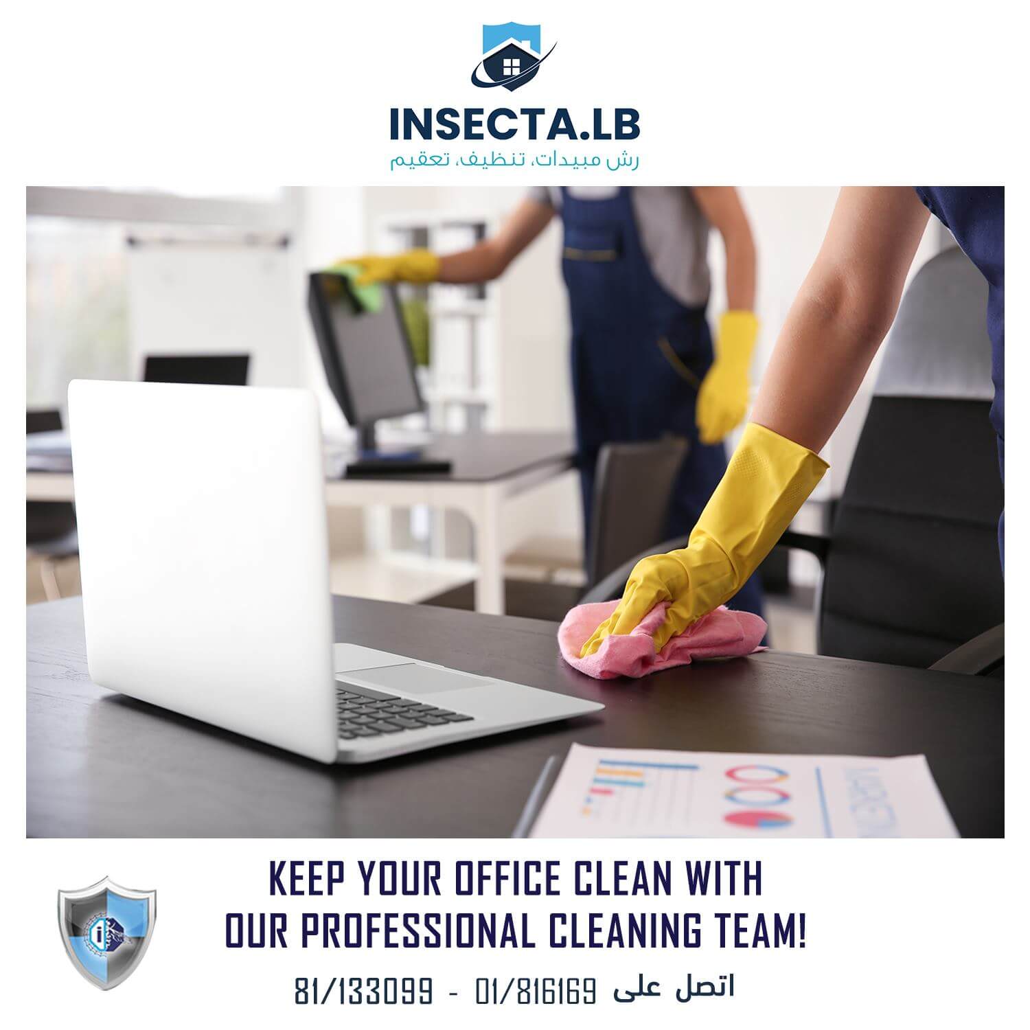 Two people cleaning an office, one wiping a desk with a laptop and papers. The other cleans a desk.