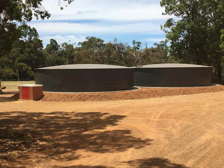 two tanks with dirt surrounding