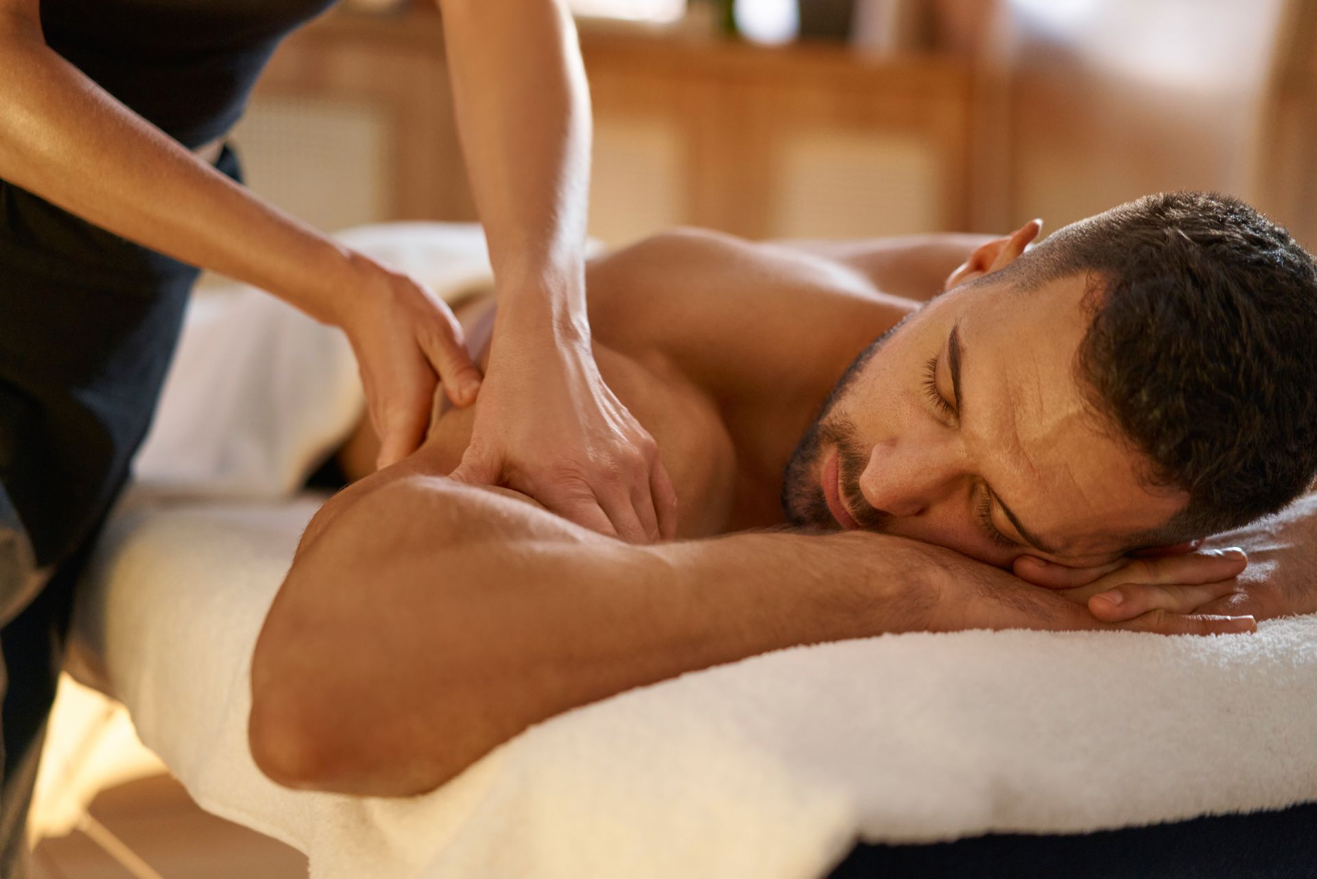 Person receiving a back massage in a spa.