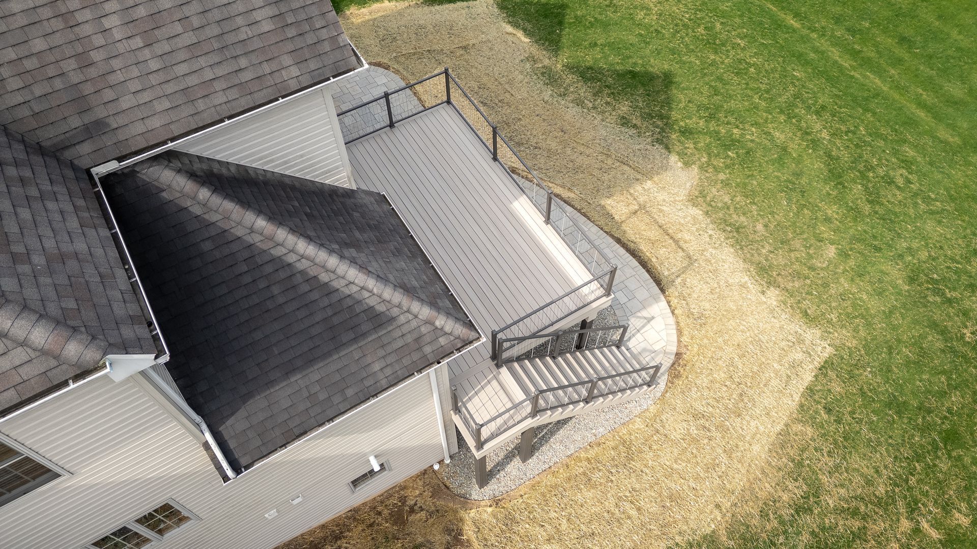An aerial view of a house with a deck and stairs.