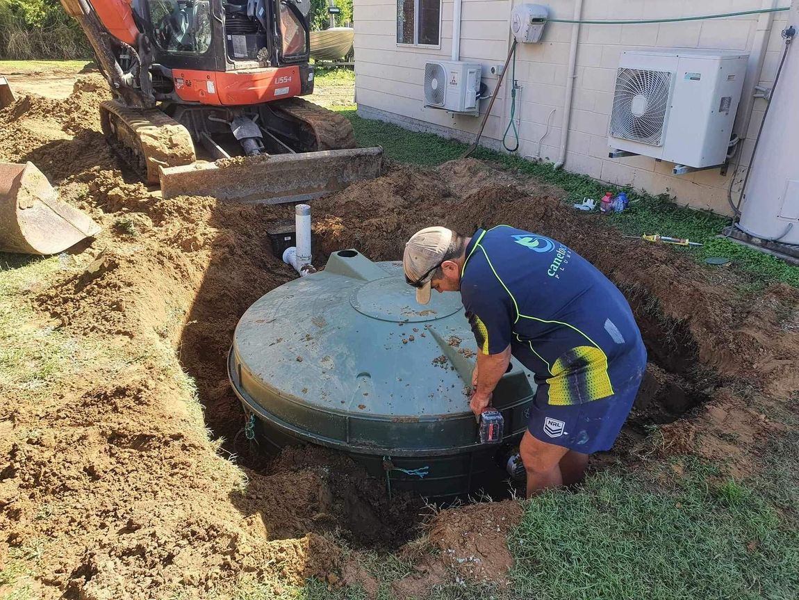 Plumber repairing outdoor water system — Qualified Plumber in Proserpine, QLD