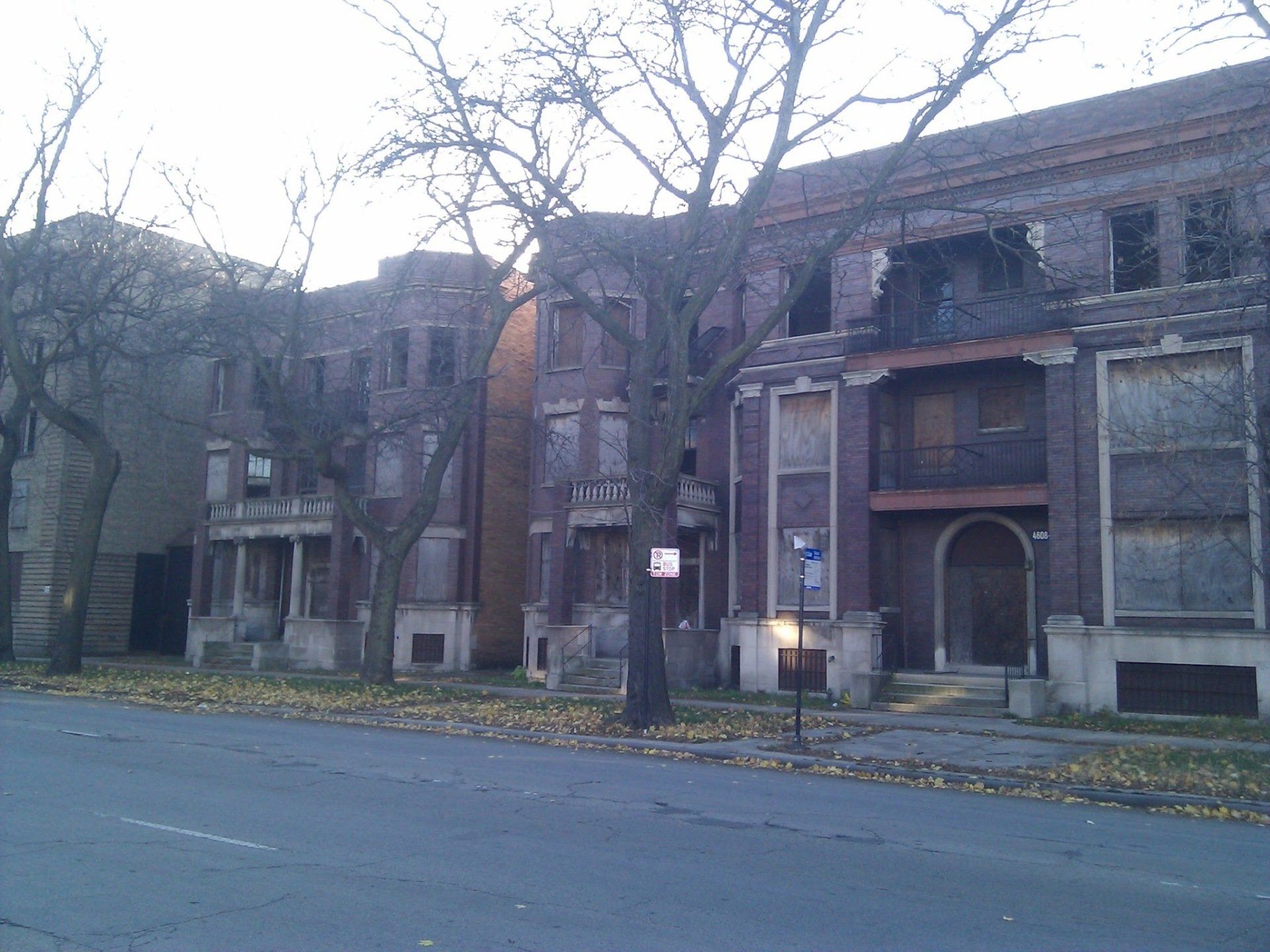 A row of brick buildings with trees in front of them