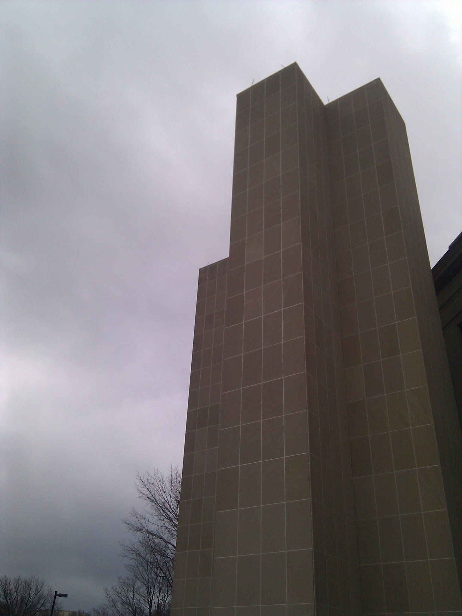 A tall building with a cloudy sky in the background
