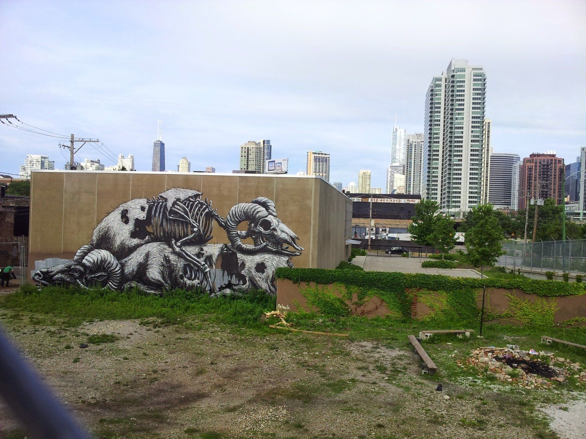 A large mural on the side of a building with a city in the background