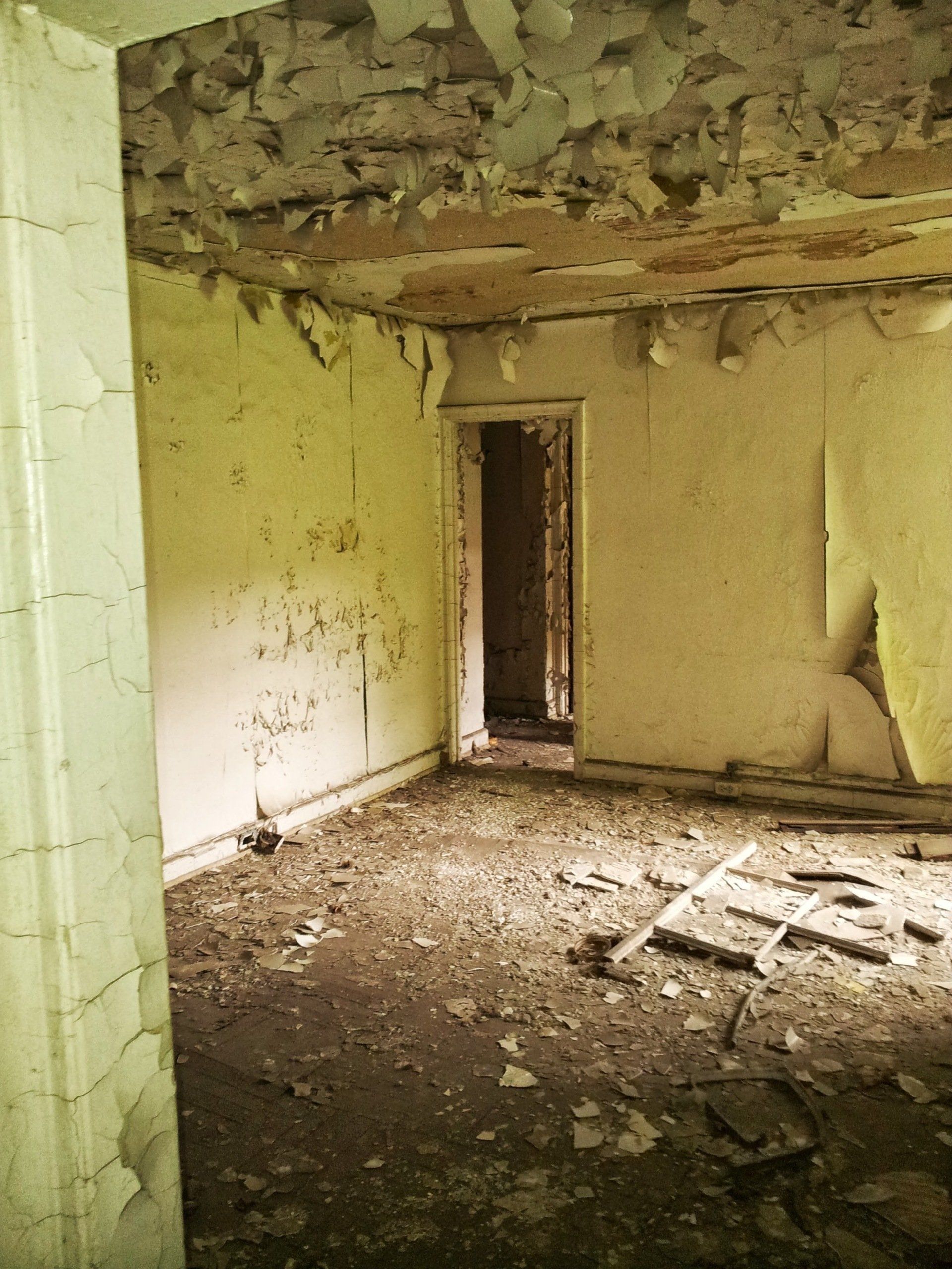 An empty room with a door in the corner