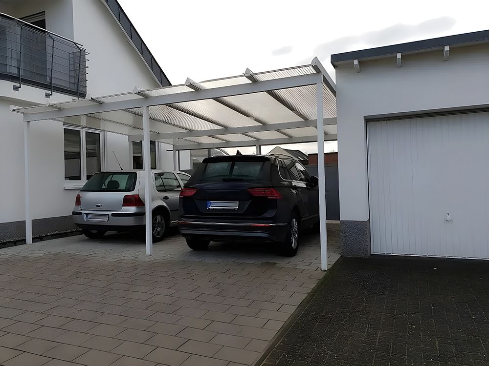 Cars Parked Under a White Carport Connected to a White House