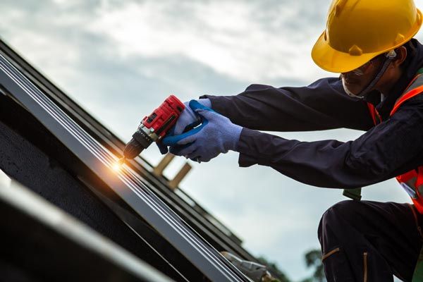 Worker Installing Metal Roof — Metal Mates in Cessnock, NSW