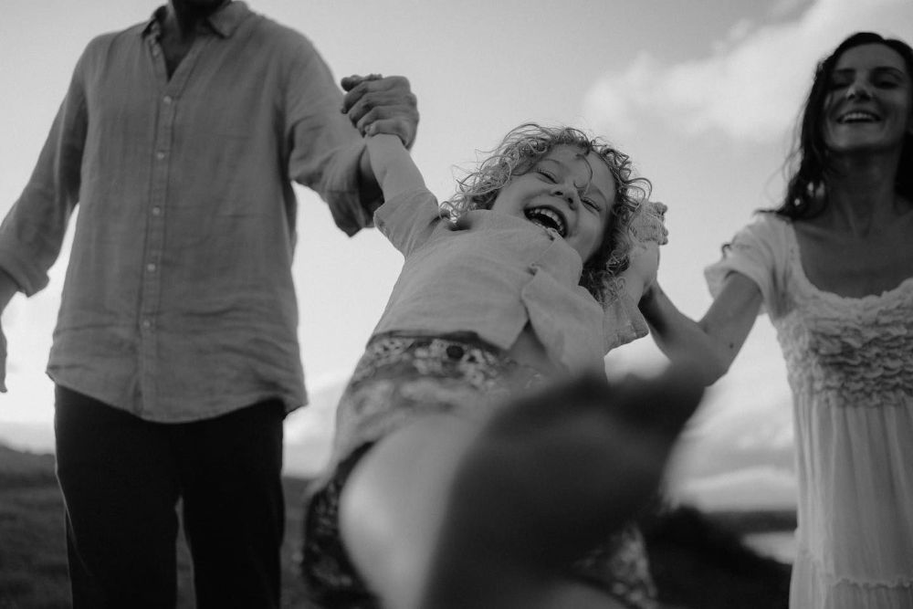 A Black and White Photo of A Family Holding Hands — Seed + Salt Photography In Coffs Harbour, NSW