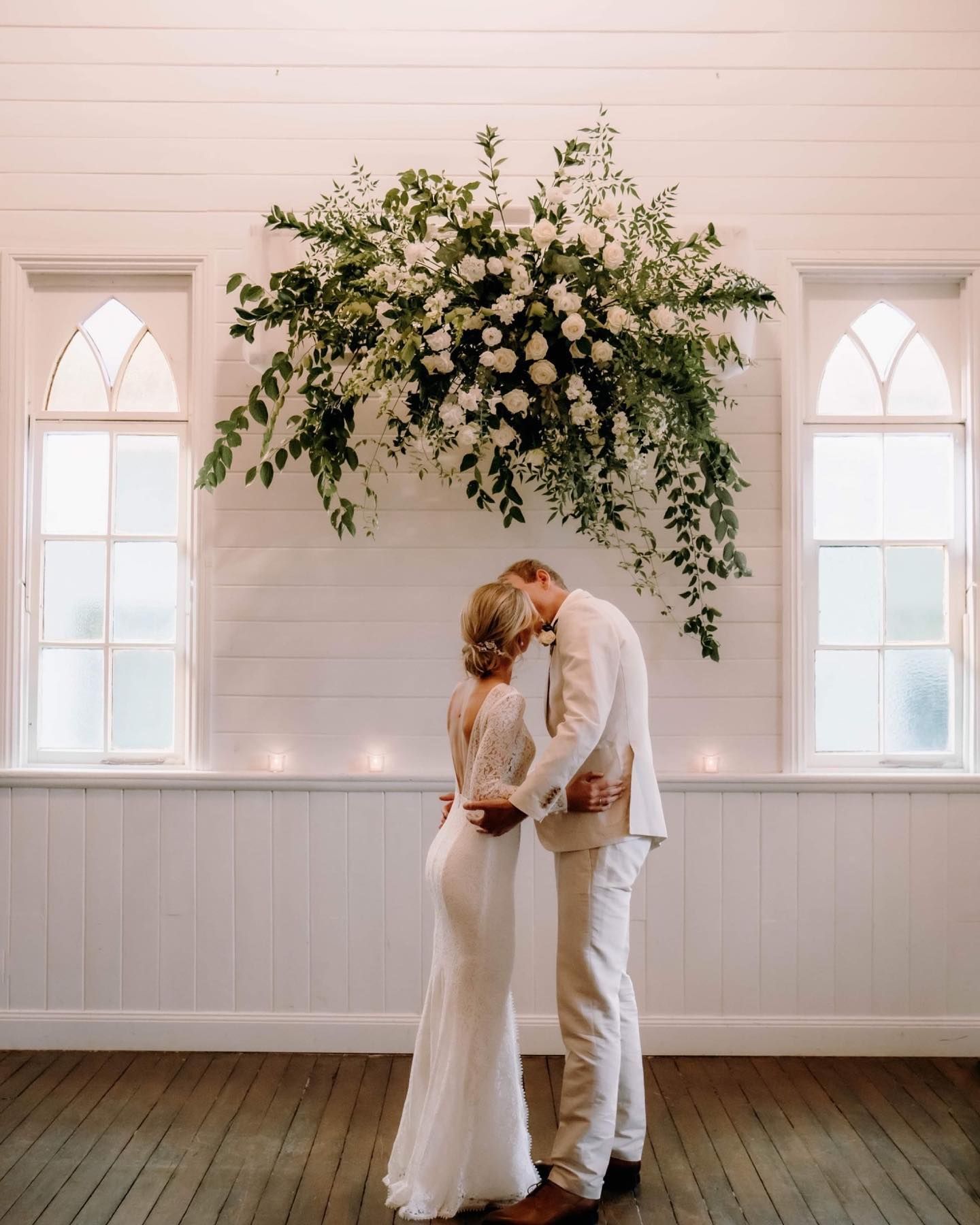 A Family Is Walking Through a Field with A Child on Their Shoulders — Seed + Salt Photography In Kempsey, NSW