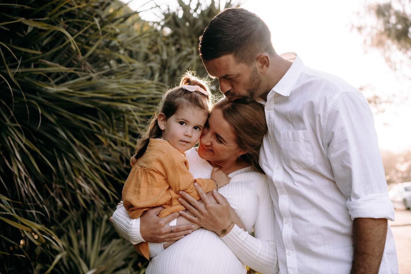 A Man Is Holding a Baby While a Little Girl Looks On — Seed + Salt Photography In Smithtown, NSW