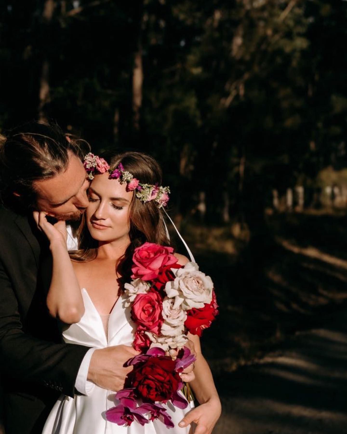 A Bride and Groom Have their Arms around Each Other Looking At Each Other Holding a Bouquet of Flowers — Seed + Salt Photography In Smithtown, NSW